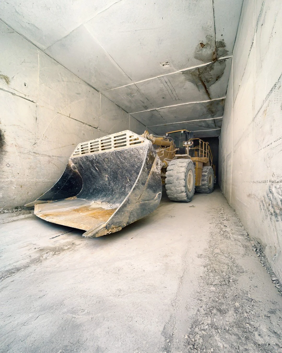 Deep in the mountains of Carrara, the work begins long before a slab reaches the studio. This bulldozer emerges from a marble tunnel carved by generations of quarrymen&mdash;where raw stone is unearthed, shaped, and prepared for its next life in arch