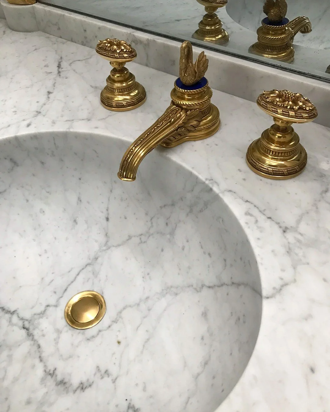 Malibu primary sink and vanity, carved from a single block of marble to create a fully integrated basin and counter. Seamless fabrication allows the veining to flow uninterrupted, highlighting the stone&rsquo;s natural character. Elegant, intentional