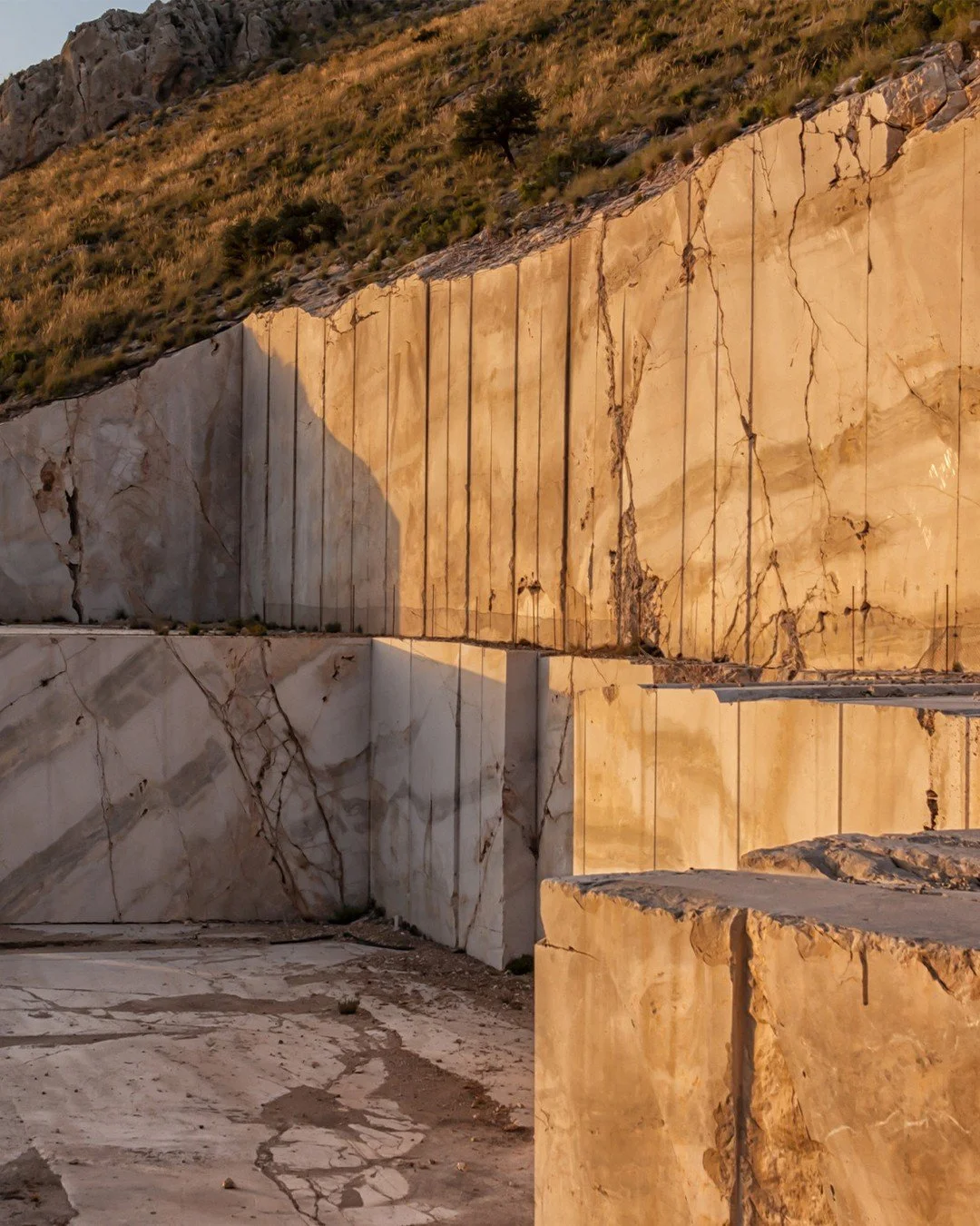 Golden light settles over the quarry as the sun sets in Andalusia. The natural warmth of the marble is revealed in this moment&mdash;clean cuts, layered geology, and the scale of the material at its source. A reminder of where these stones begin, lon