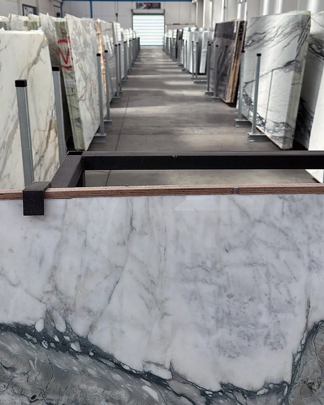 This is not a stone yard. It's a collection.

Hundreds of slabs &mdash; Calacatta, Arabescato, rare marbles from quarries most suppliers have never visited &mdash; standing at the Unico Design Lab warehouse in Medley, ready for your next project. No 