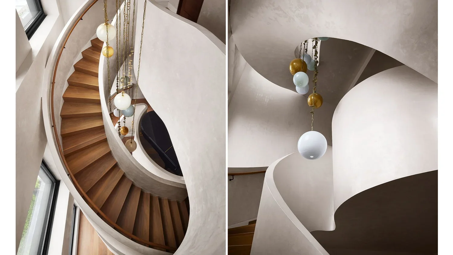 Interior of a modern spiral staircase with wooden steps, white walls, and hanging decorative globe lights.