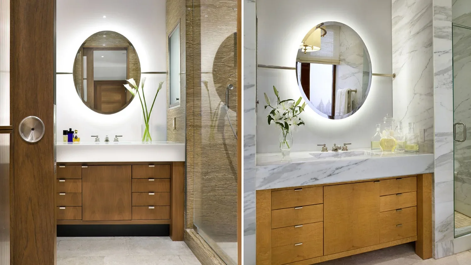 Comparison of two bathroom vanities with wooden cabinets and illuminated circular mirrors, one with a white marble countertop and the other with a white solid surface, each with a vase of white lilies and various toiletries.