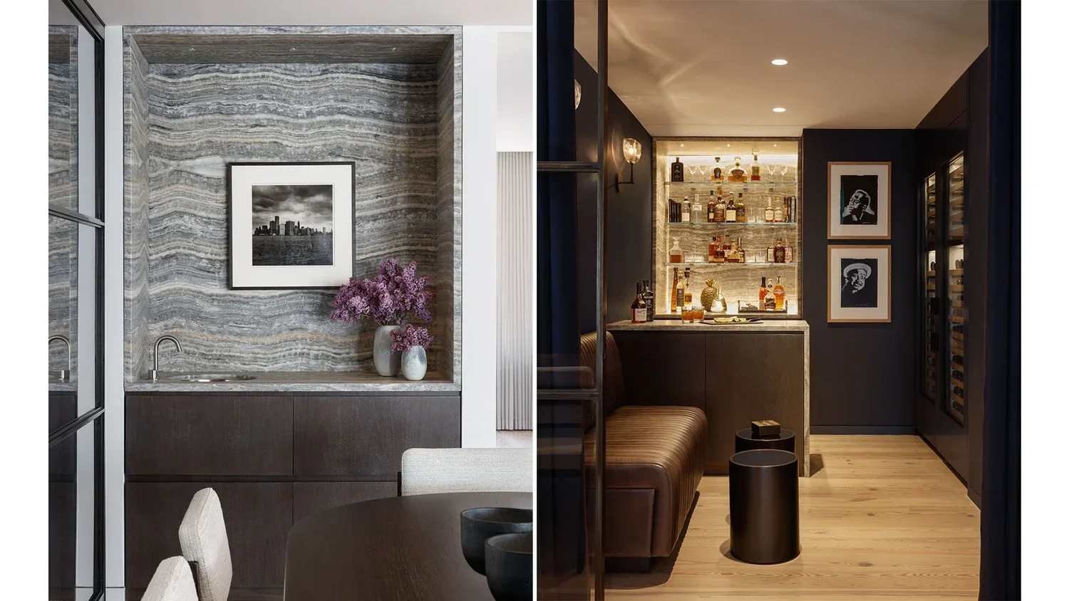 Interior view of a modern dining room on the left with a dark wood sideboard, a gray striped stone wall, a black-and-white cityscape photo, and vases with purple flowers. On the right, a cozy bar area with bottles on glass shelves, framed artwork, a 