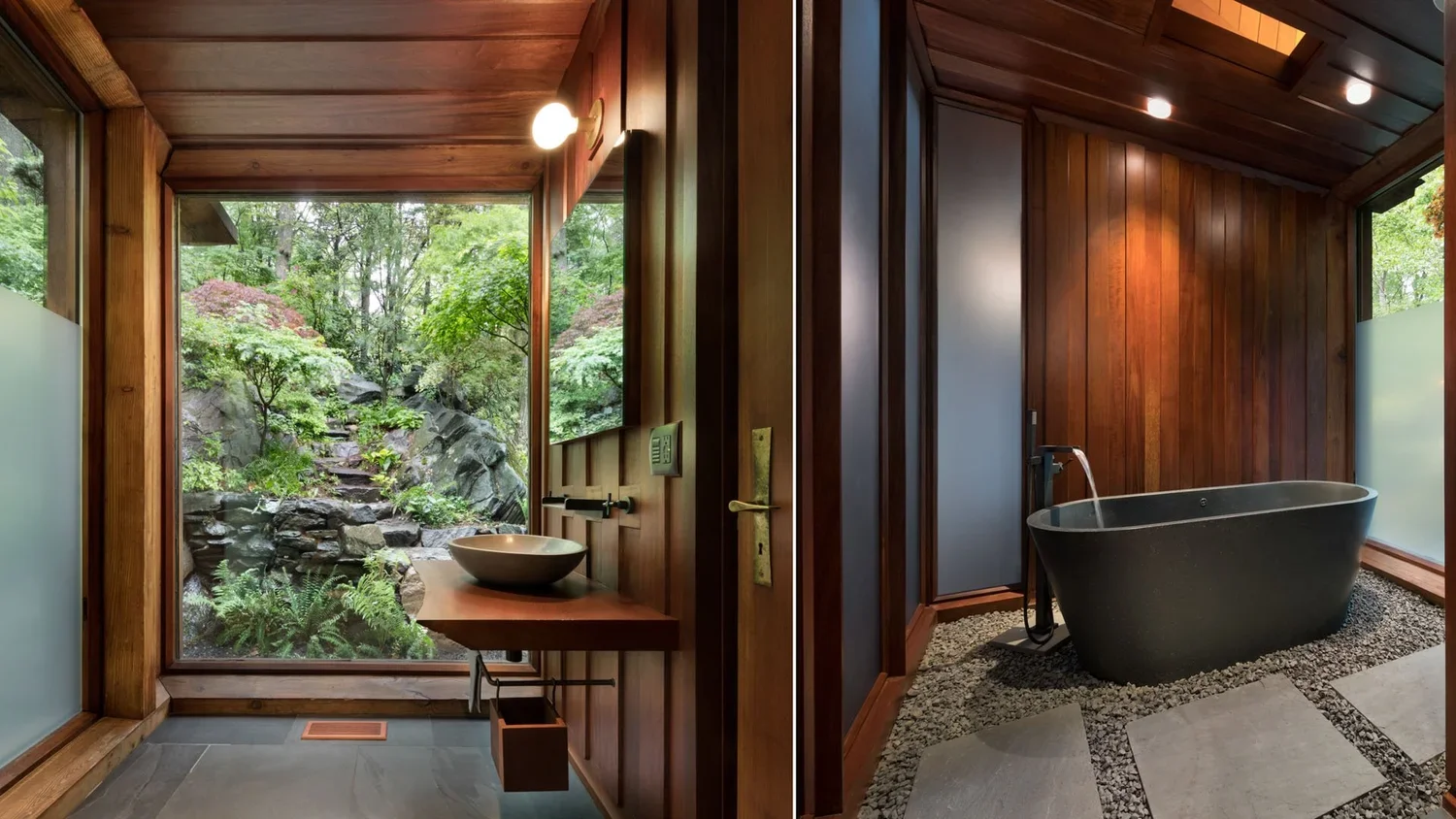 A bathroom with wooden walls and ceiling, featuring a large window overlooking a lush, green garden. The bathroom has a modern sink with a circular bowl and a faucet. There is a black freestanding bathtub with a water faucet on a bed of small pebbles