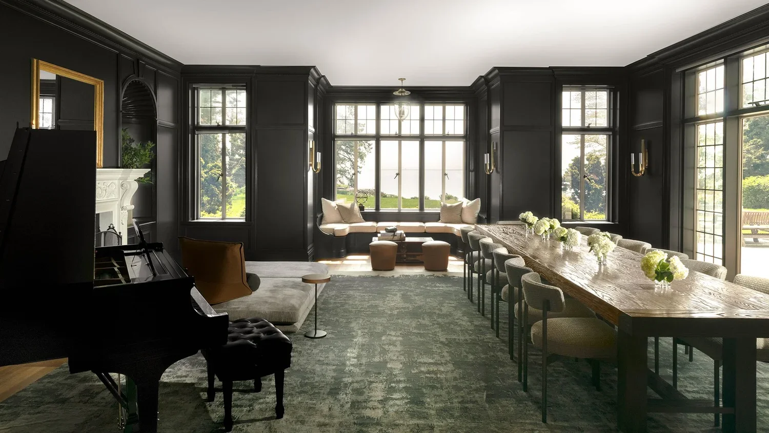 Elegant dining room with black paneled walls, large windows, a long wooden table with floral centerpieces, a built-in window nook with cushions, a grand piano, and a gray carpet.