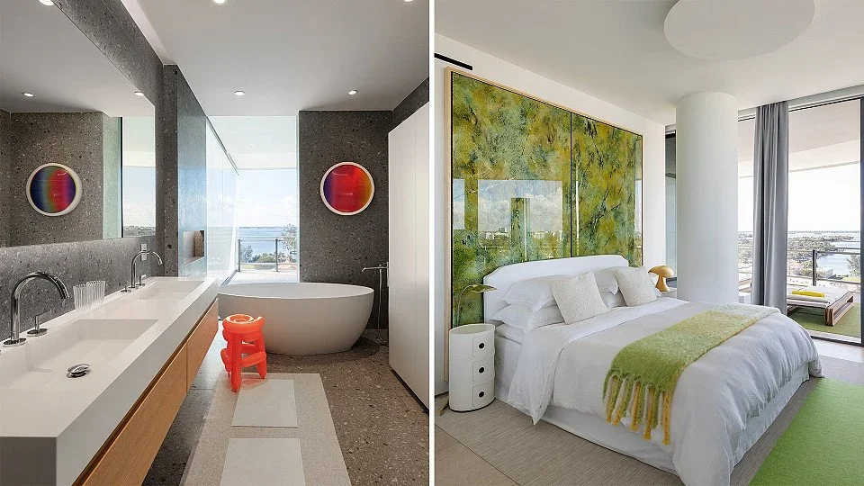 A modern bathroom with a freestanding bathtub, double sinks, and colorful art, and a contemporary bedroom with a large bed, green accents, and city view.