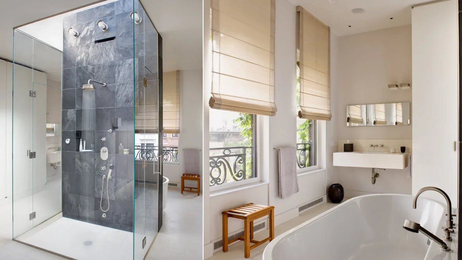 Modern bathroom with a large glass-enclosed shower area, a freestanding bathtub, and a vanity with a mirror. The room features white walls, beige window shades, and decor items like a black vase and small containers.