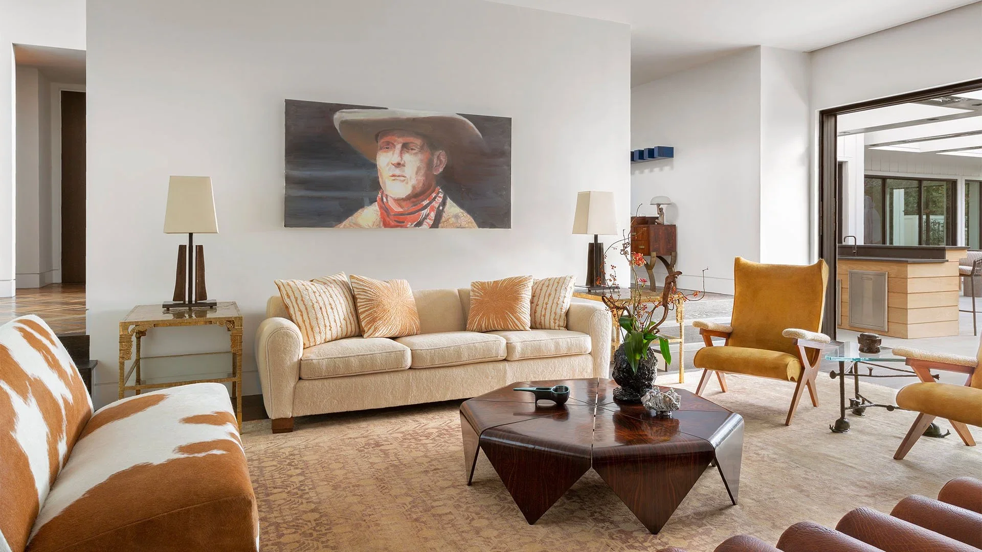Modern living room with cream sofas, yellow chairs, wooden coffee table, and artwork of a cowboy on the wall.