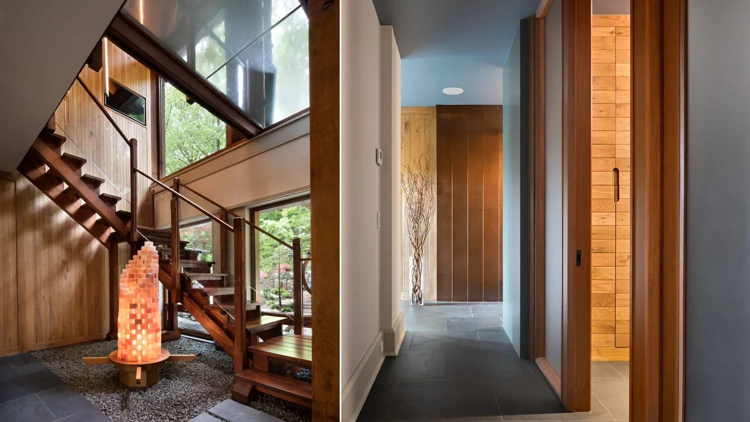 Interior view of a modern house featuring a wooden staircase on the left, a decorative salt lamp on a wooden platform, and a hallway with wood-paneled doors and stone flooring. Large windows reveal greenery outside.