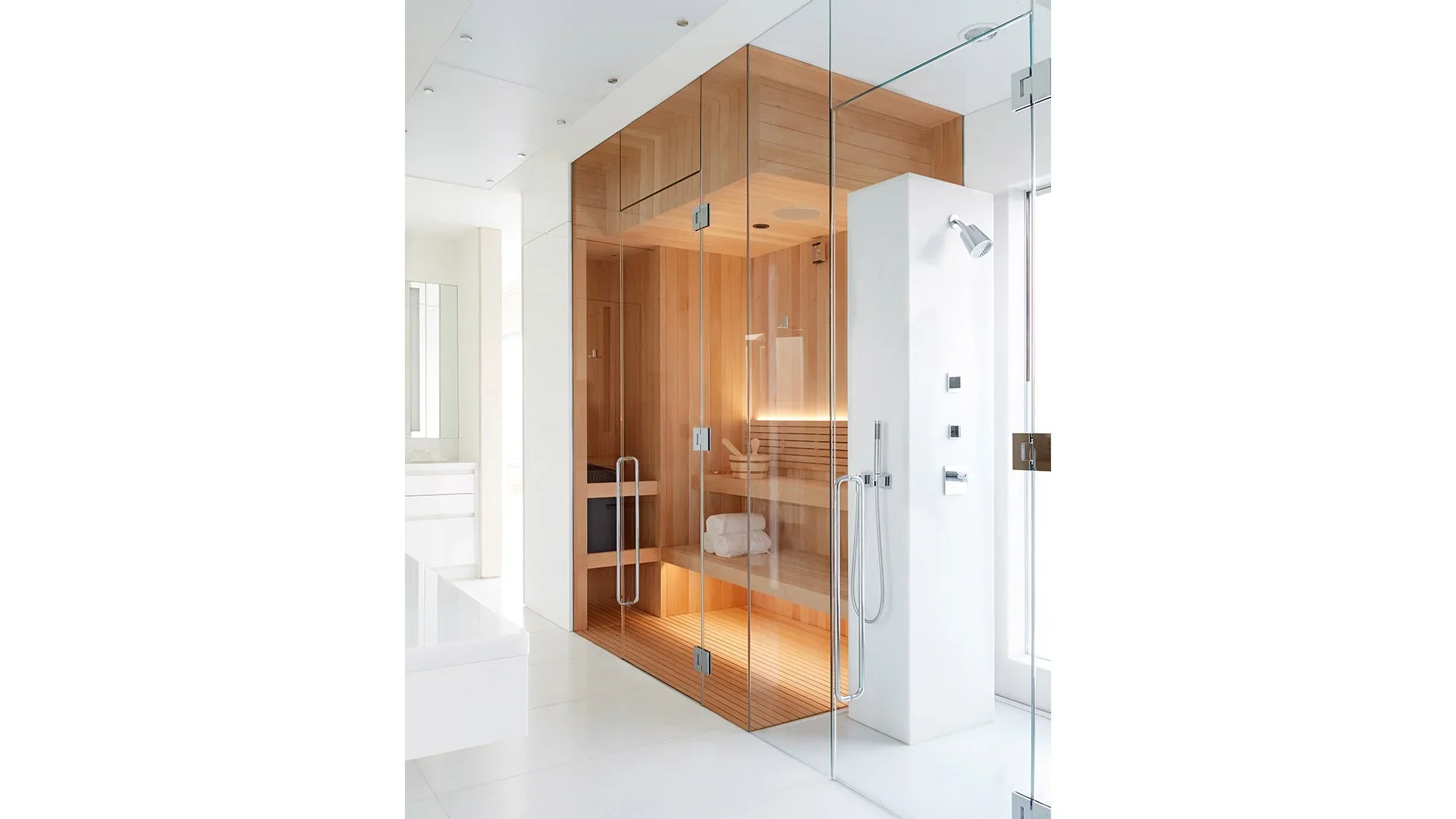 Modern glass-enclosed shower with wooden interior and seating, located in a bright, minimalist bathroom.