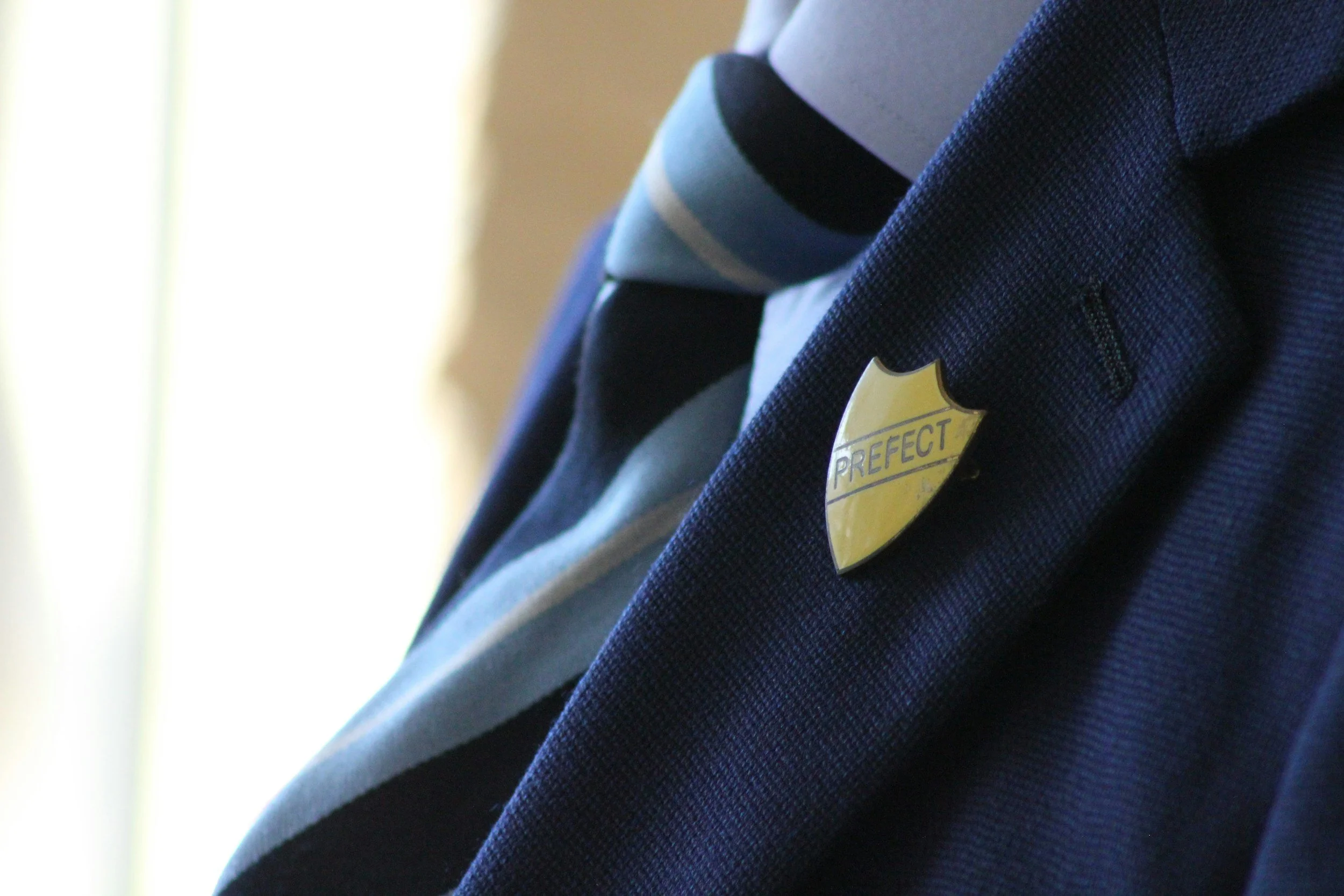 Yellow prefect badge on a blazer