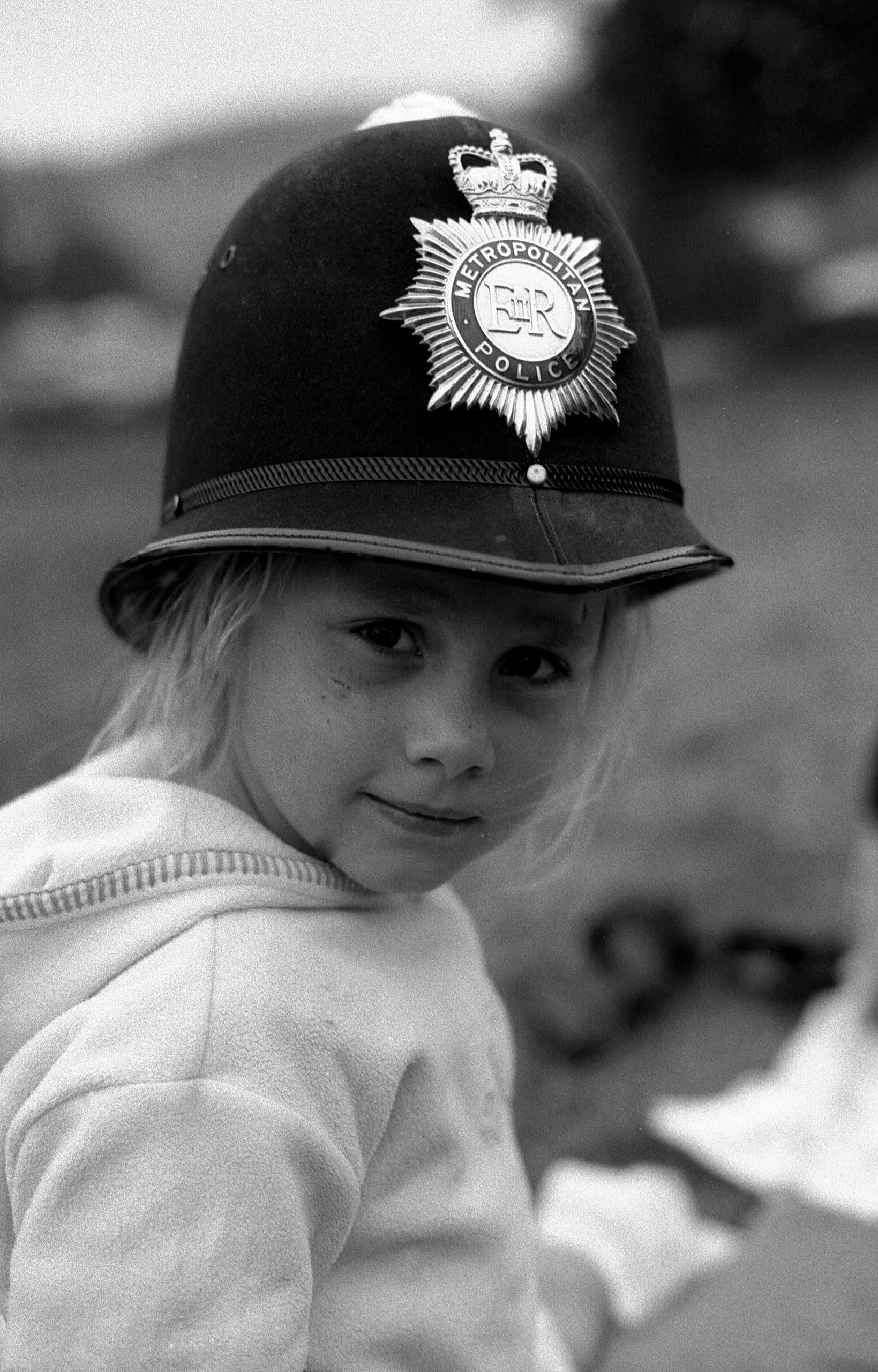 Girl wearing policeman's helmet, 2002.