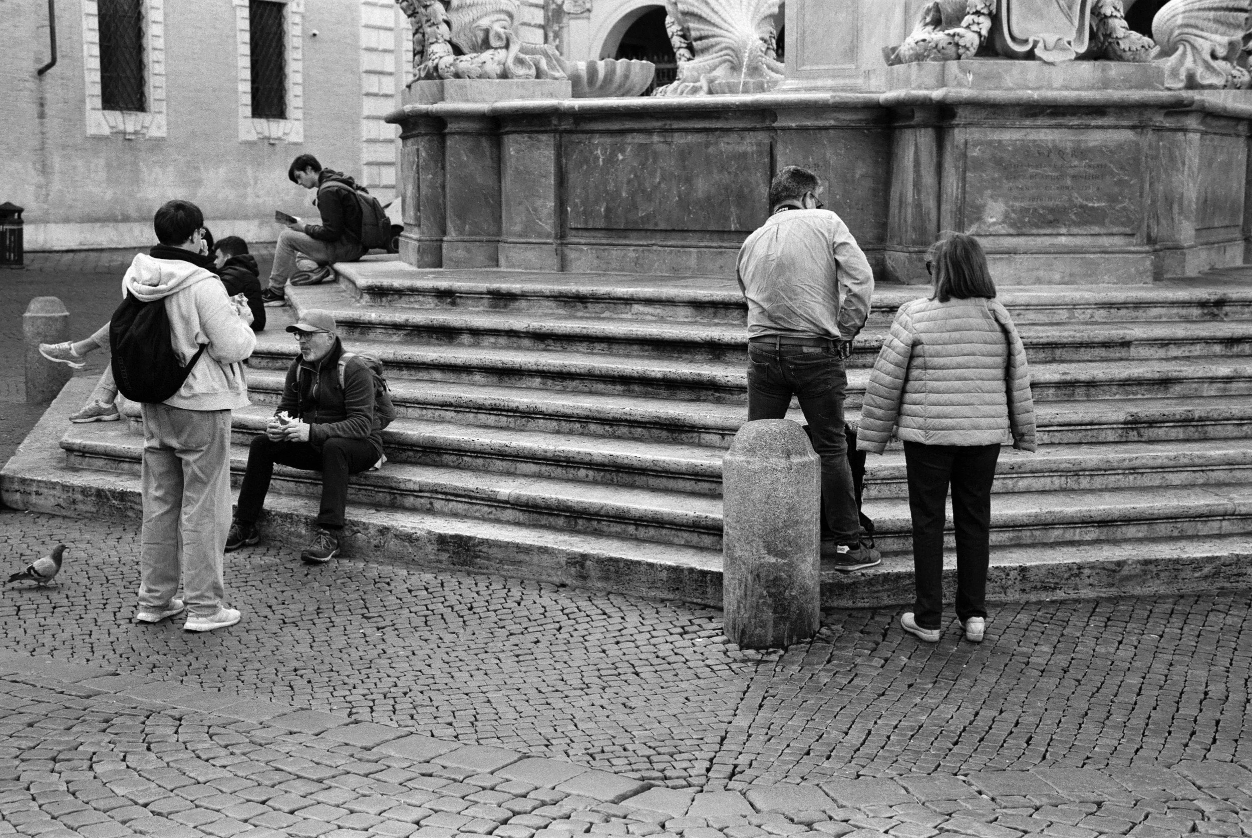 Relaxing by the fountain in the Piazza Di Santa Maria, Trastevere, Rome. Cinestill XX, ISO 200.