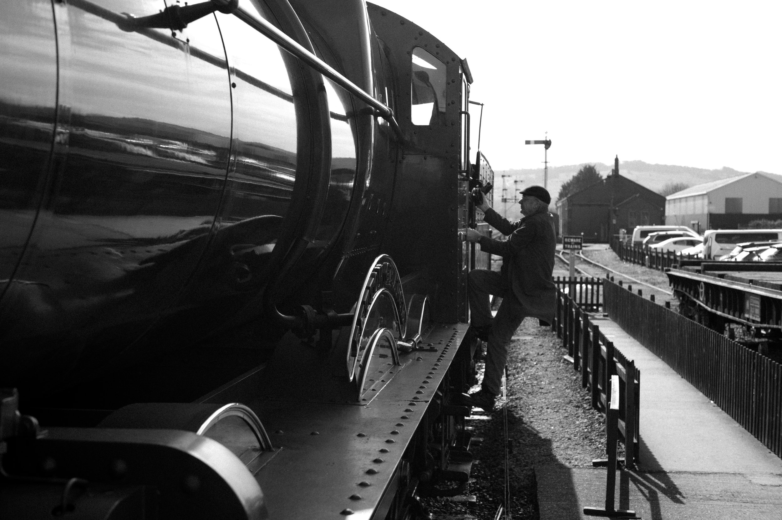 Fireman climbing down from the cab. 