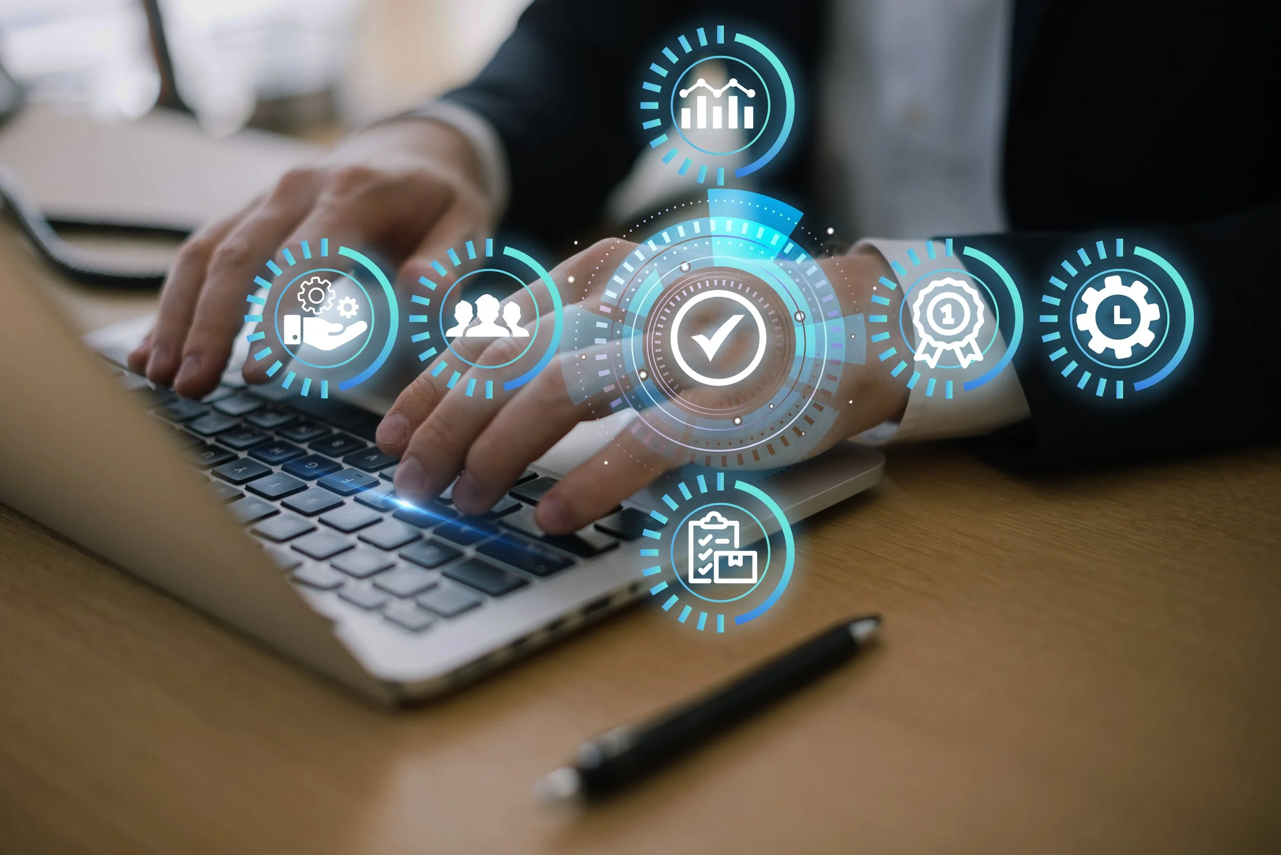 Person using a laptop with digital icons representing data analysis, teamwork, verification, awards, efficiency, and organization floating over the keyboard.