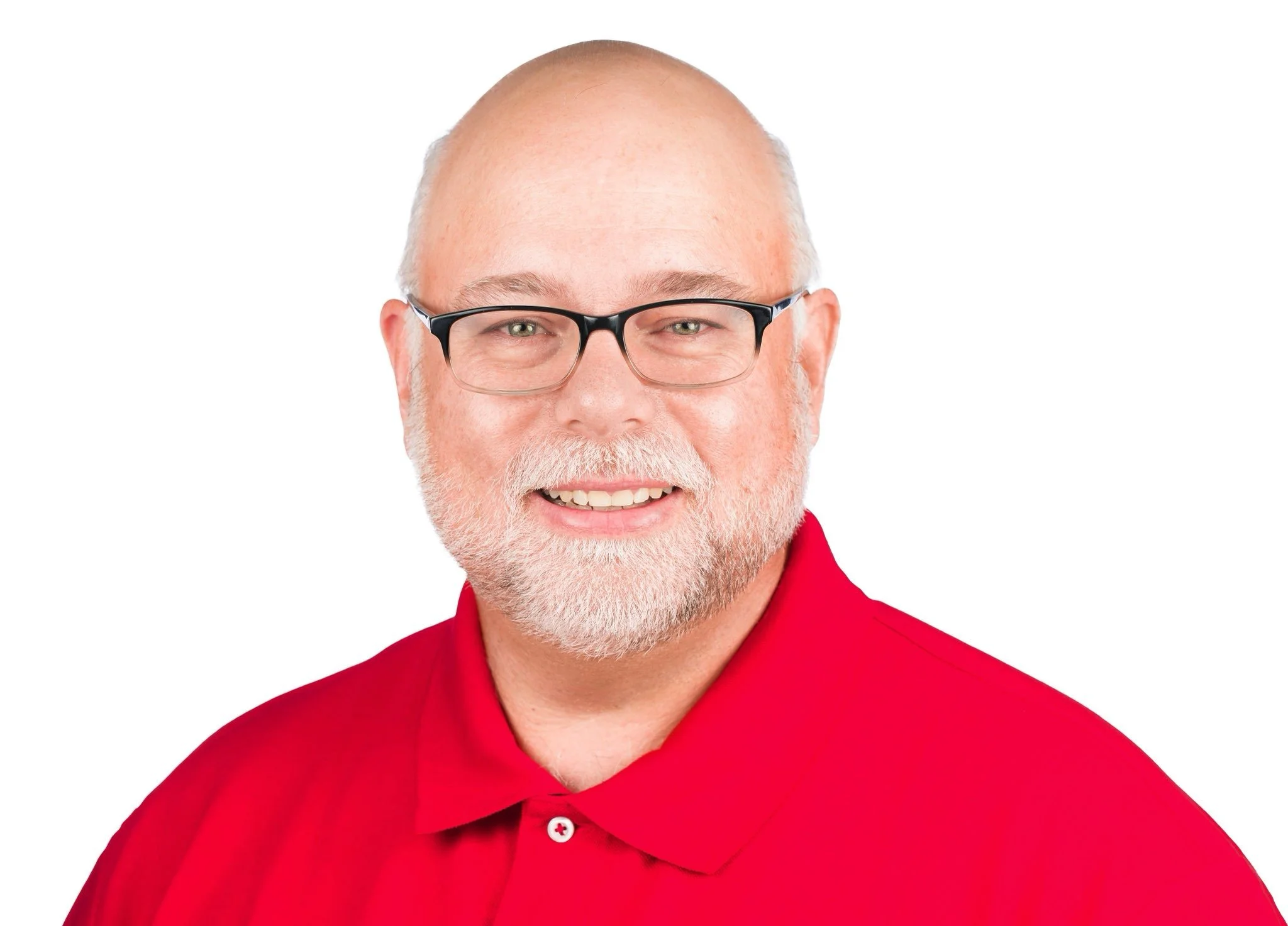 A smiling man with a red polo shirt and glasses is smiling into the camera in a headshot position with a white background.