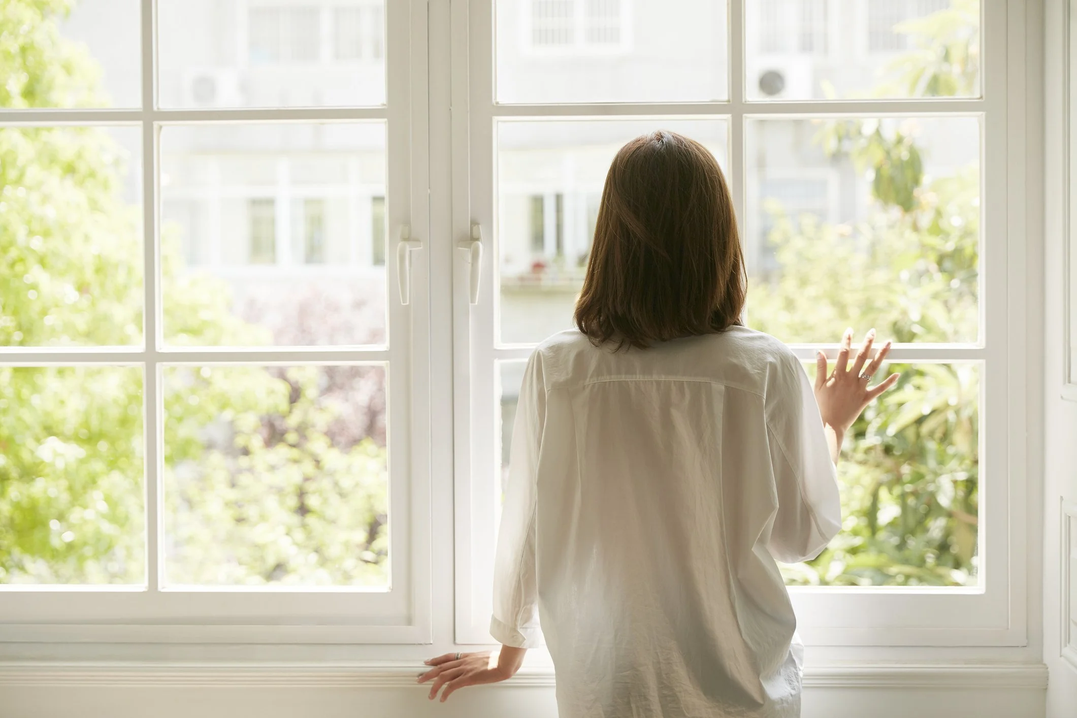 Woman thinking quietly by the window