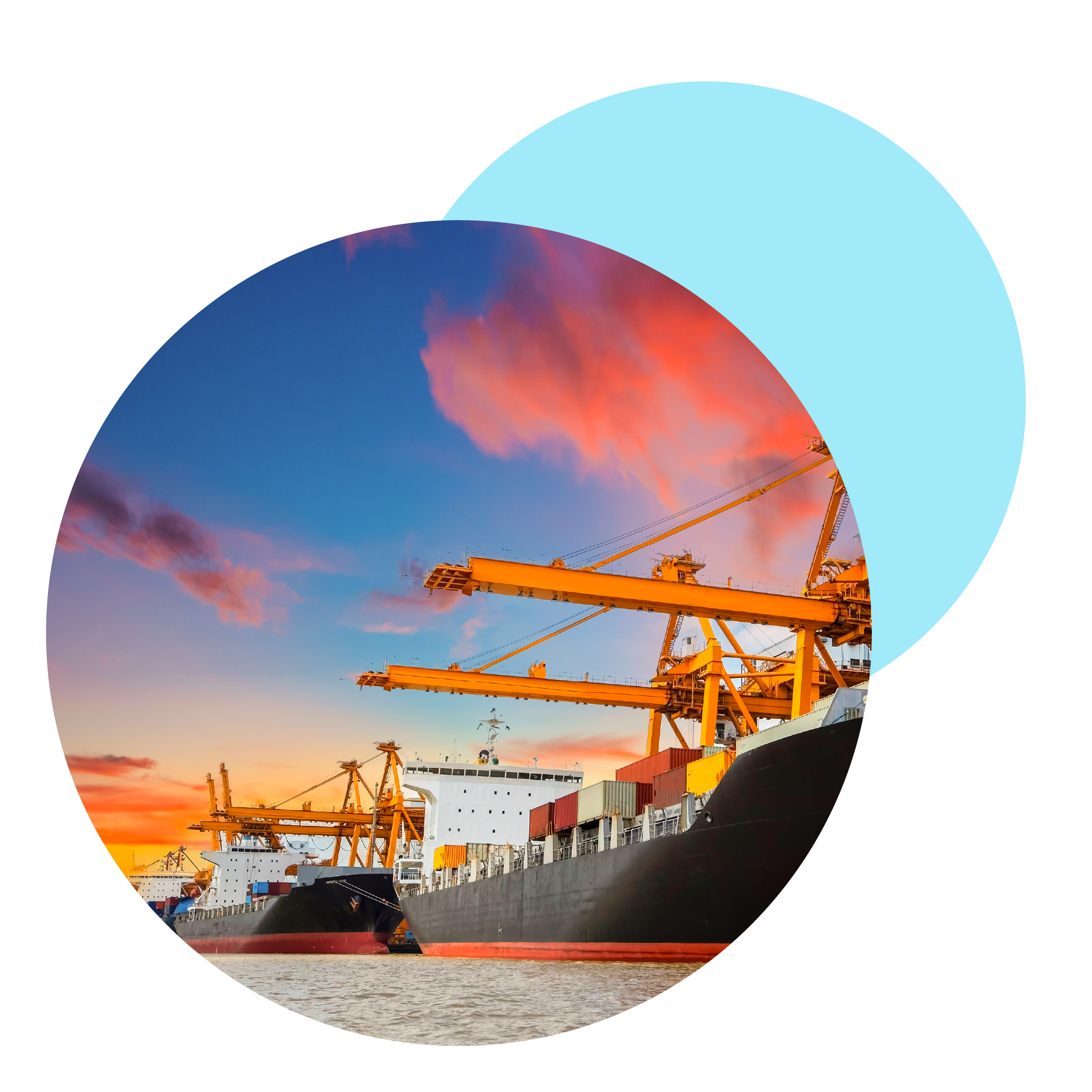 Cargo ships docked at port during sunset with colorful clouds in the sky.