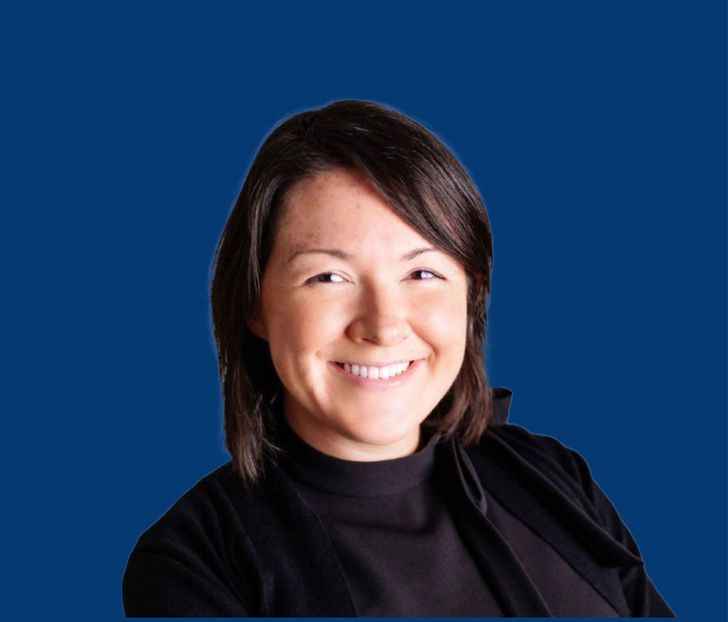 Portrait of a smiling woman with shoulder-length dark brown hair, wearing a black top, against a solid blue background.