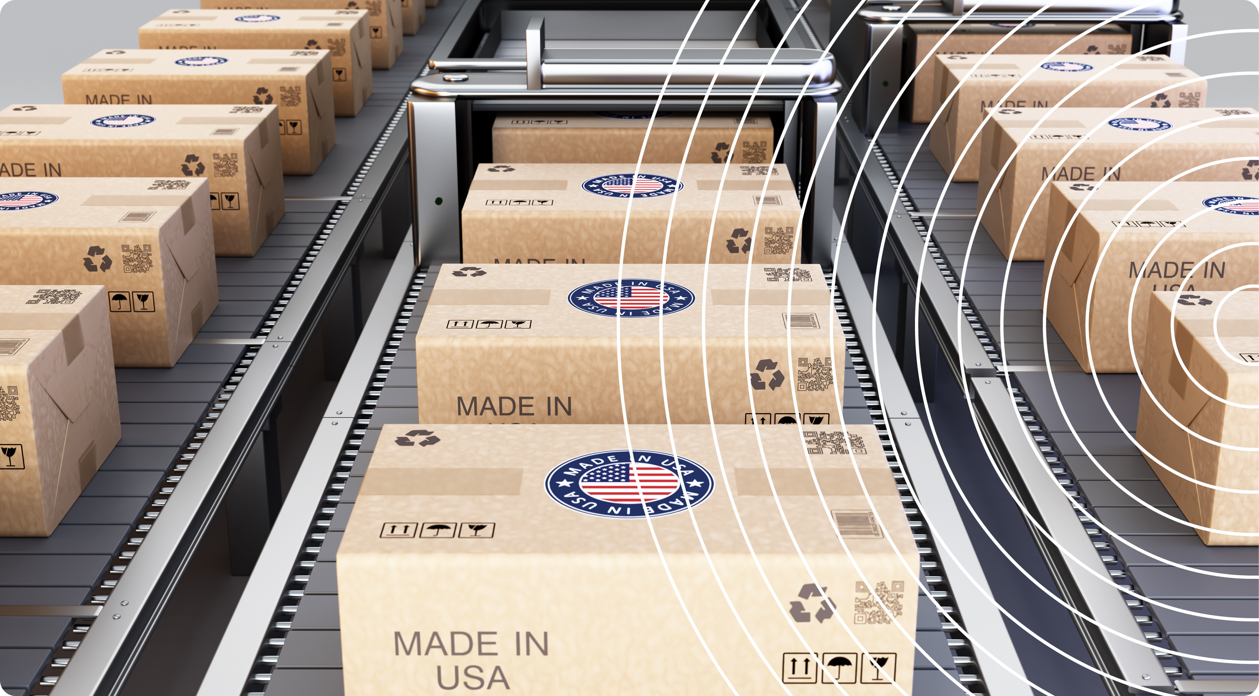 Boxes moving along a conveyor belt in a manufacturing or packaging facility, with the label 'Made in USA' and the American flag emblem on each box, as well as recycling symbols and handling instructions.