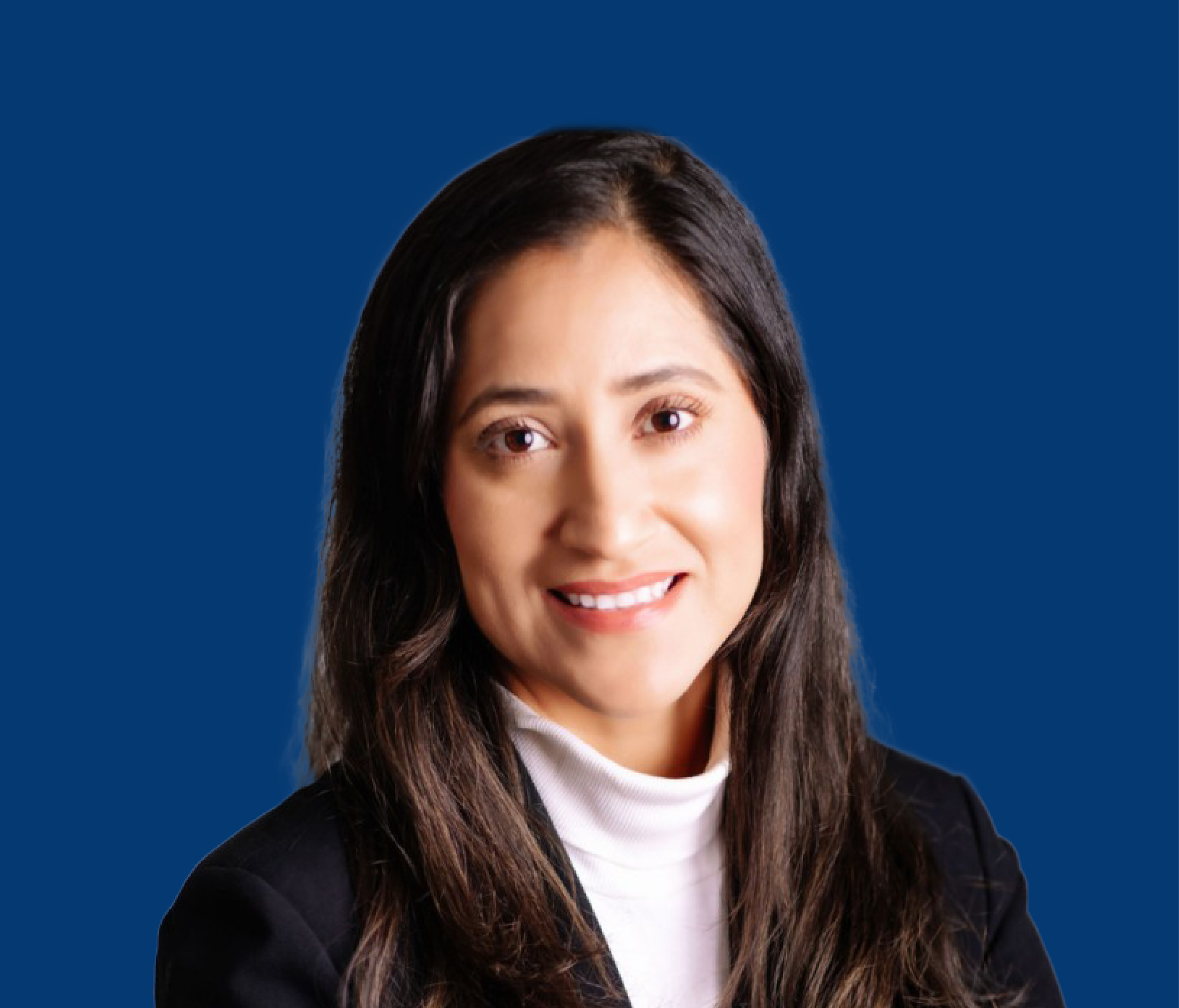 Portrait of a woman with long dark hair, smiling, wearing a black blazer and white turtleneck, against a solid blue background.