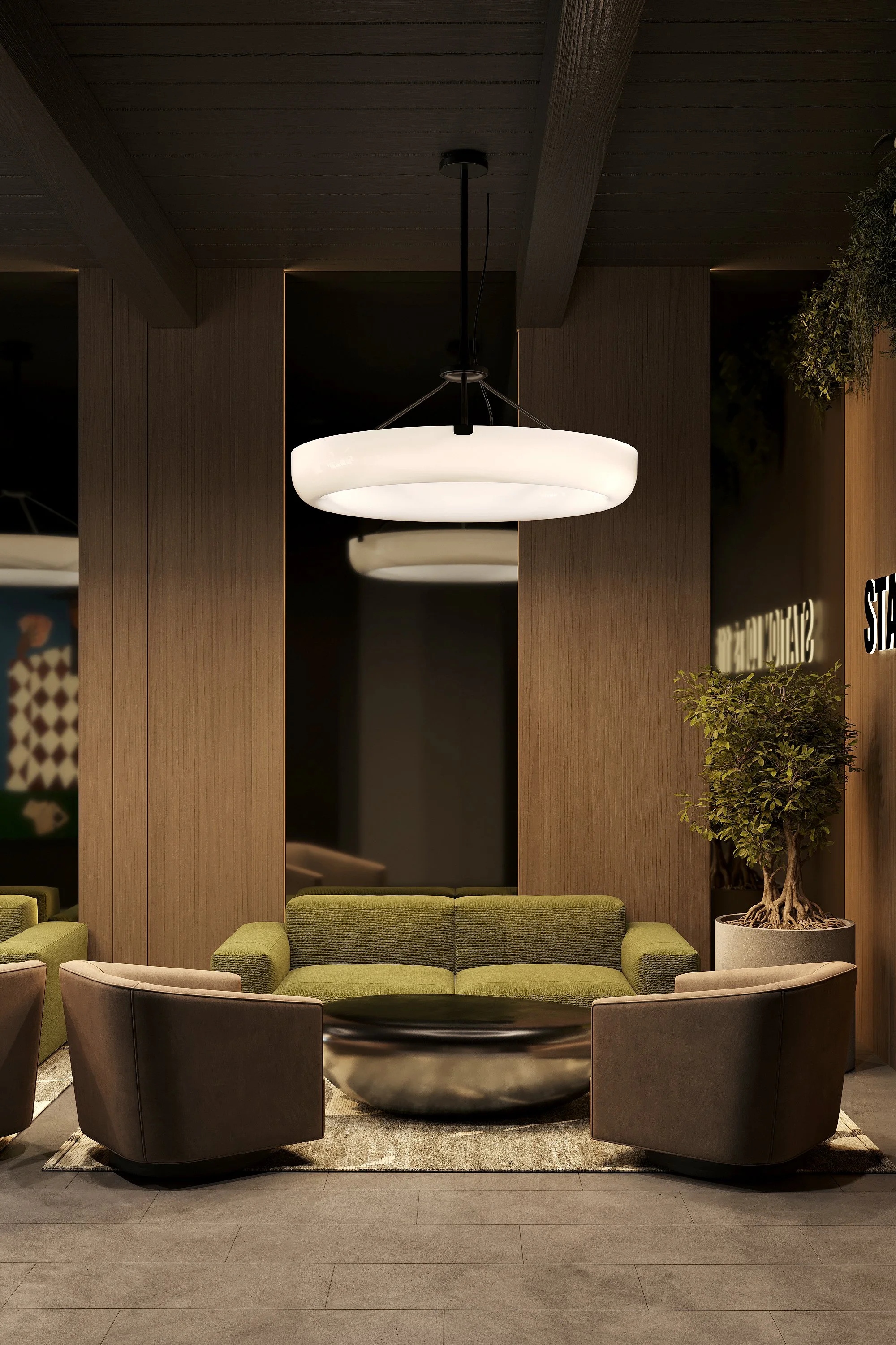 Modern hotel lobby seating area with green sofa, two beige armchairs, and large black coffee table, illuminated by a large circular ceiling light, with wooden wall panels and potted plant.