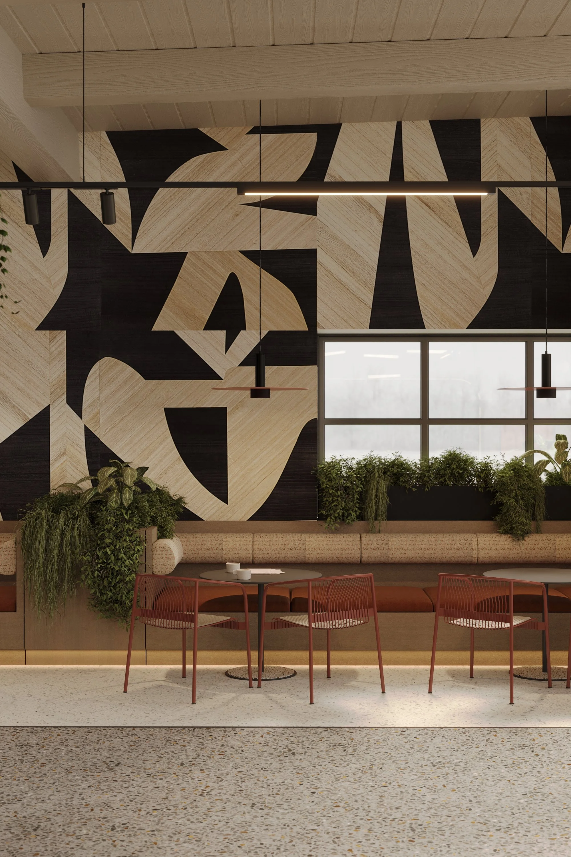 Modern interior with a patterned black and beige wall, a long beige cushioned bench, potted green plants, and red chairs around round tables.