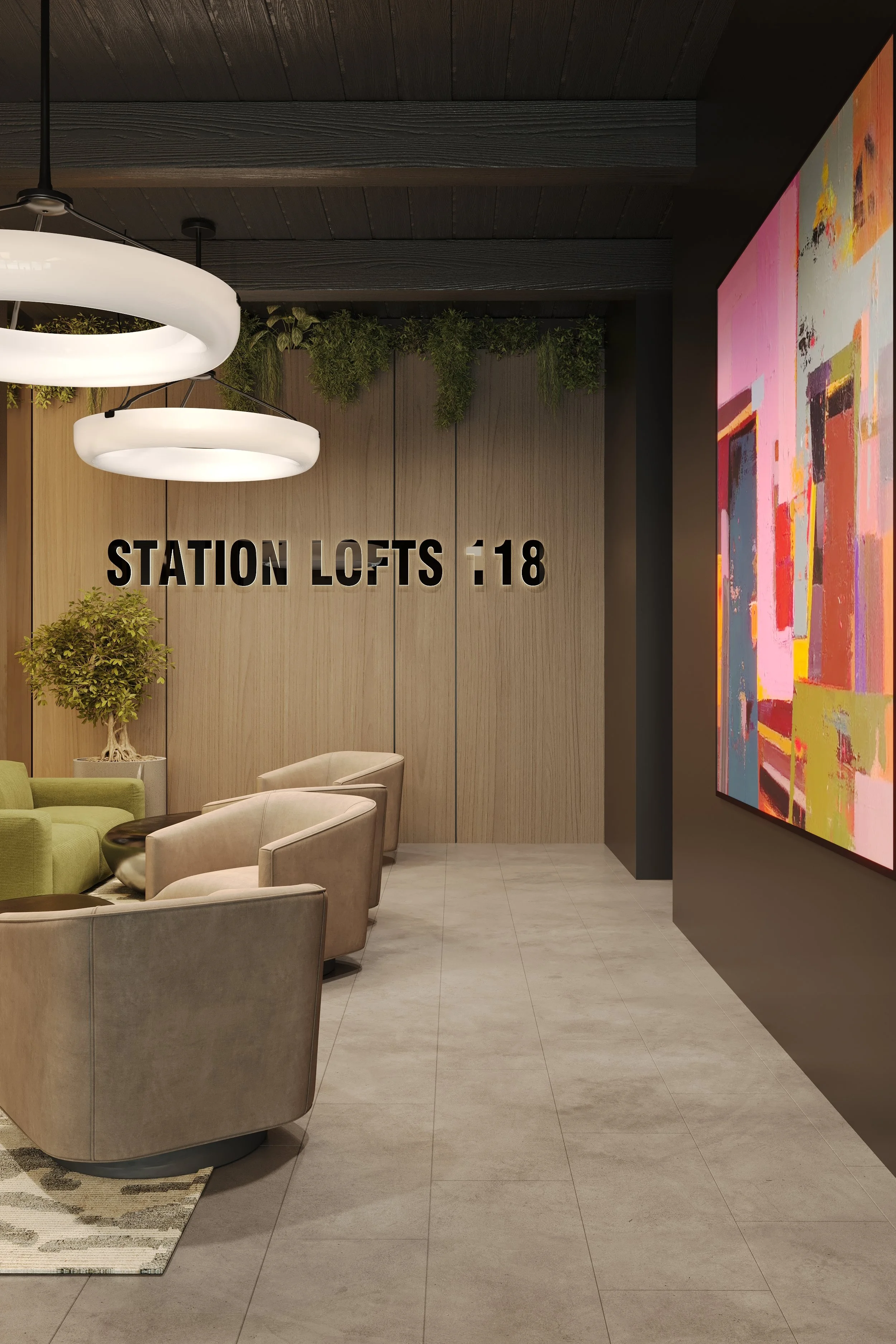 Lobby area with beige and green seating, a plant in a white pot, modern lighting fixtures, a large colorful abstract painting, and a wall sign that reads 'STATION LOFTS 1:18'.