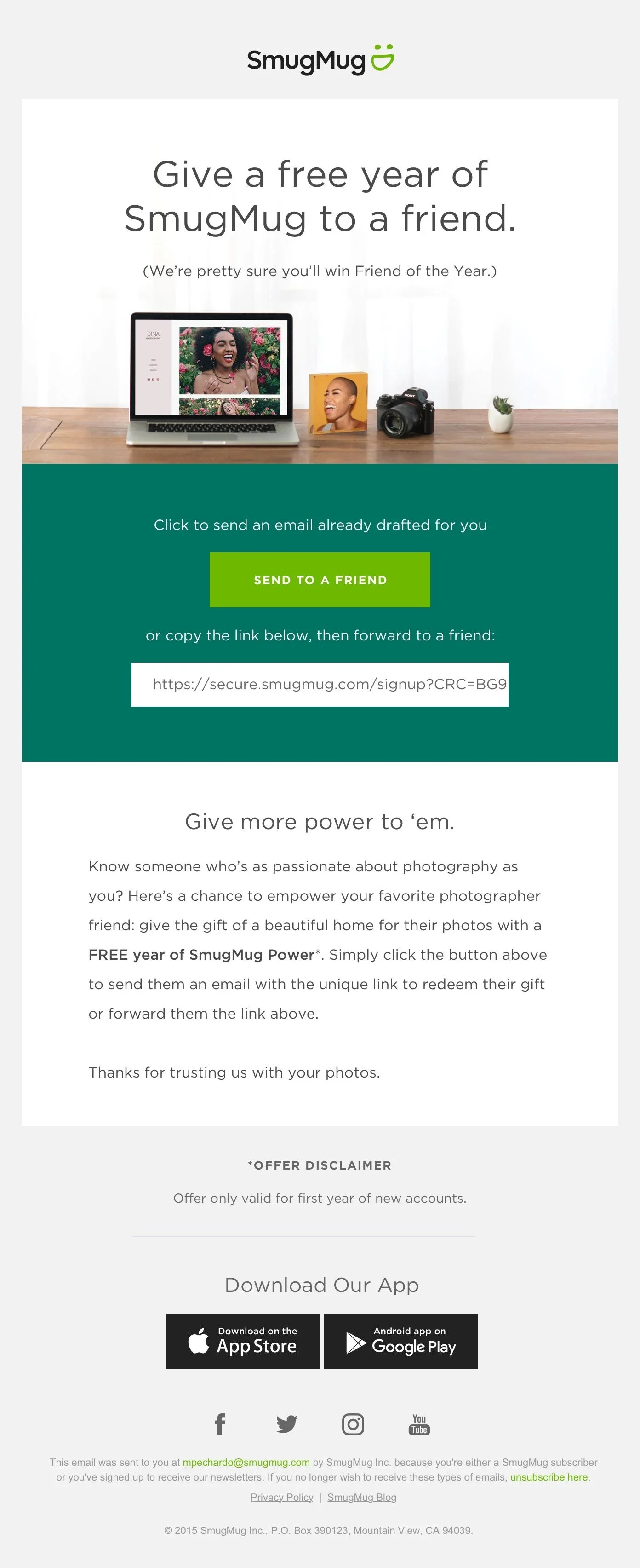 Promotional email from SmugMug offering a free year of service to gift to a friend, featuring a laptop, camera, and photographs on a desk.