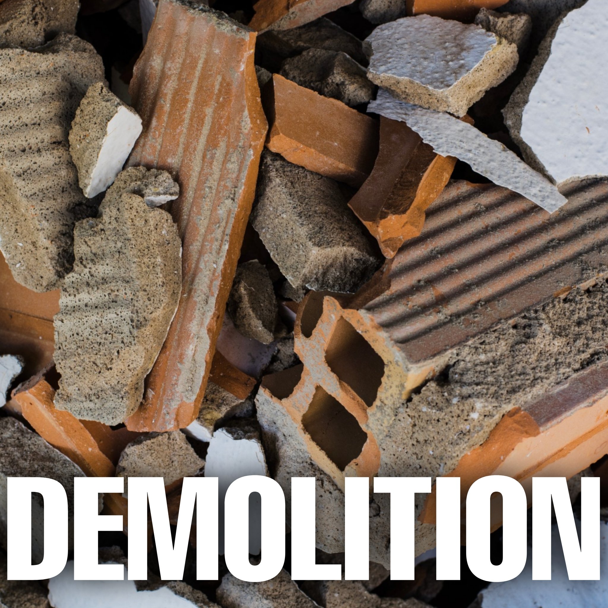 Close-up image of broken bricks and concrete debris with the word 'DEMOLITION' written in large white text at the bottom.