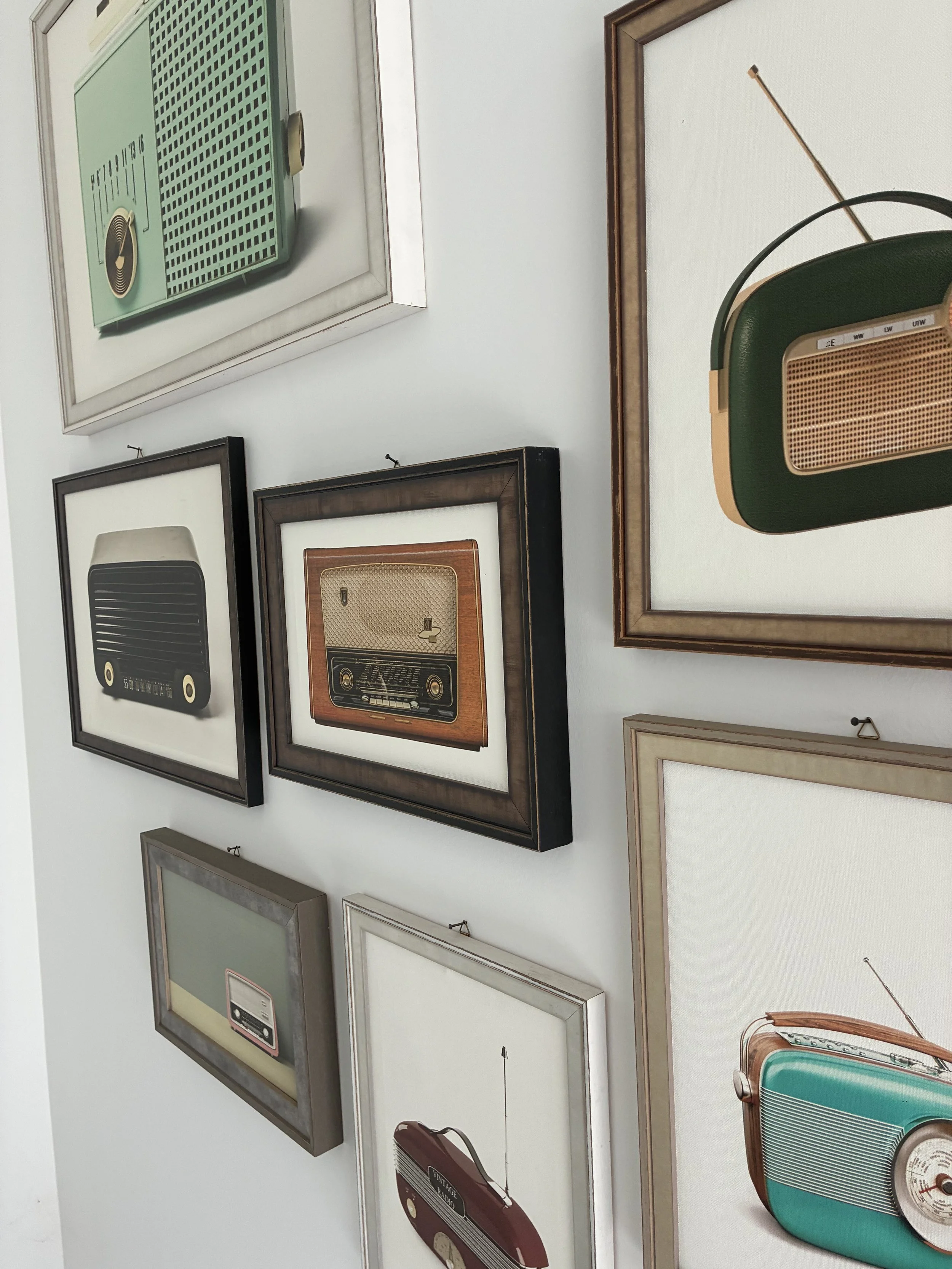 Parete con radio d’epoca incorniciate; esempi di cornici artigianali — LgM Cornici, Ferrara.