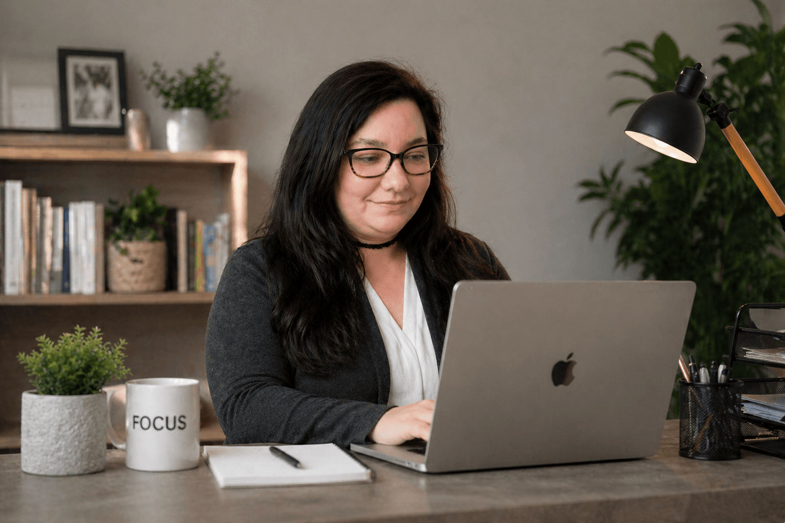 Bookkeeper typing on laptop at desk managing small business financial records