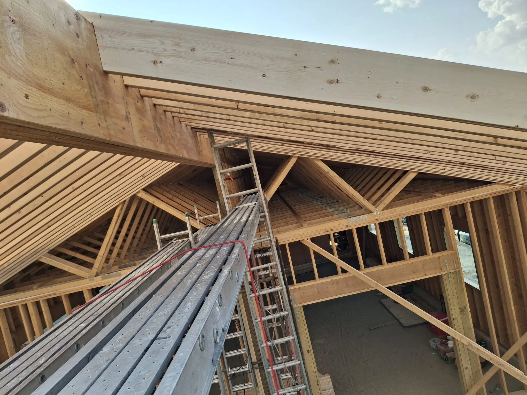 Construction site with wooden framing and scaffolding for building framework.