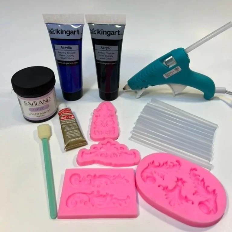 Steps 6-11: Paint with 2 coats of acrylic paint. Add a layer of UV resin for a glossy porcelain finish. Use silicone molds and hot glue to make decorative filigrees. Paint the filigrees with Rub 'n' Buff gold powder. Use hot glue to add glass gems. L