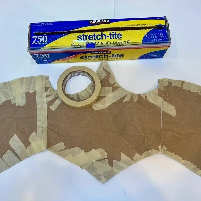 Step 1: Make custom corset pattern by wrapping myself in plastic wrap, then a layer of masking tape, then cutting it off myself and tracing it onto brown bag paper.