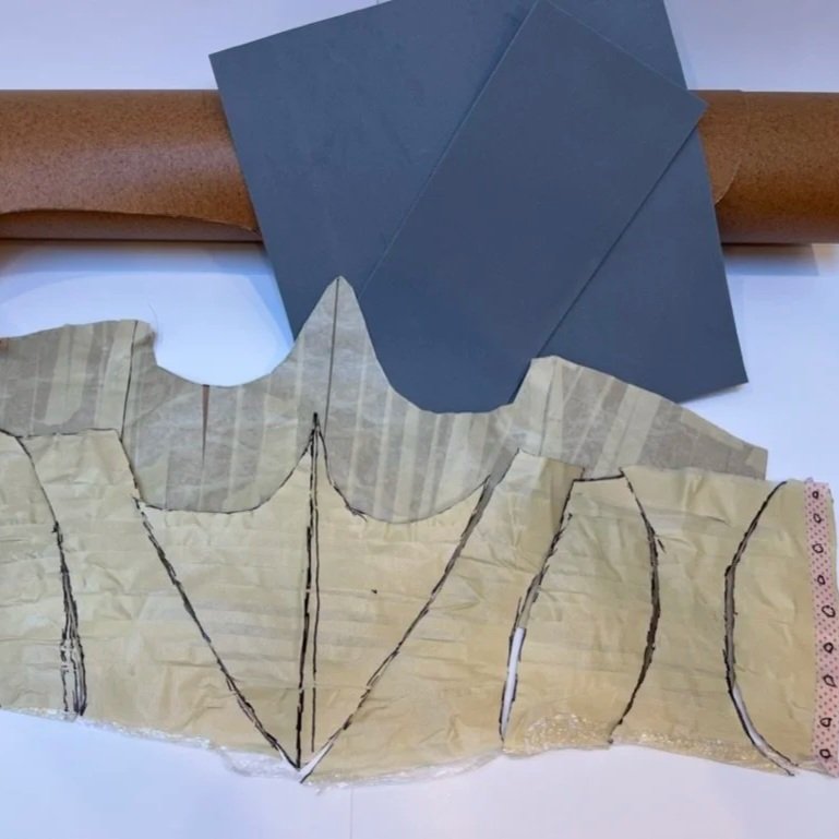 Steps 2-5: Cut pattern into 8 contoured pieces. Trace pieces onto thin foam sheets and thermoplastic sheets. Use heat gun to fuse pieces together into corset shape. Punch holes along both sides of the back seam for lacing.