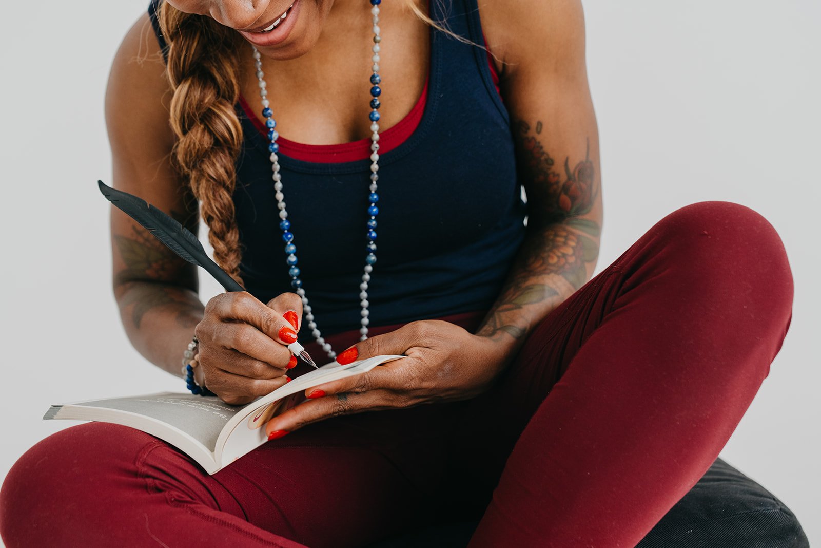 A woman journals, reflecting on aparigraha and letting go in daily life.