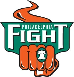 Logo for Philadelphia Fight, featuring a stylized orange winding road, the word 'FIGHT' in large green and white letters, and a clenched fist with the Liberty Bell in the center.