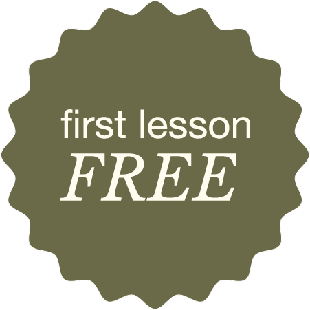 Badge with a green background and scalloped edges displaying the words 'first lesson FREE' in white and beige text.
