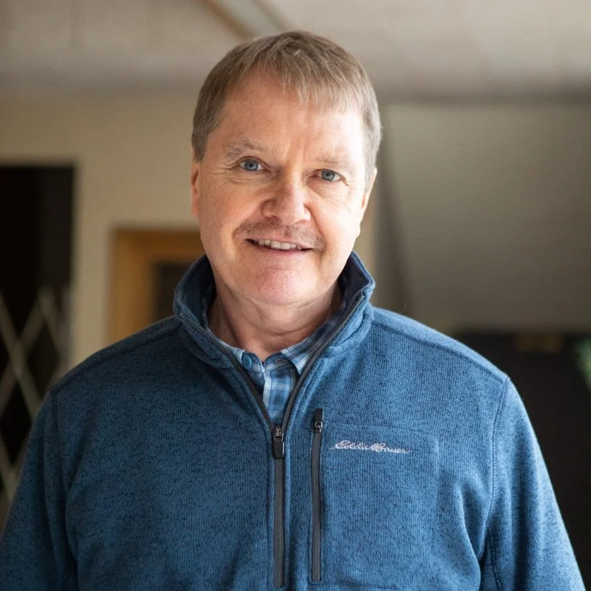 Jericho Road Ministries' Director, Jeff Noyed, smiling and standing indoors in a well-lit room.