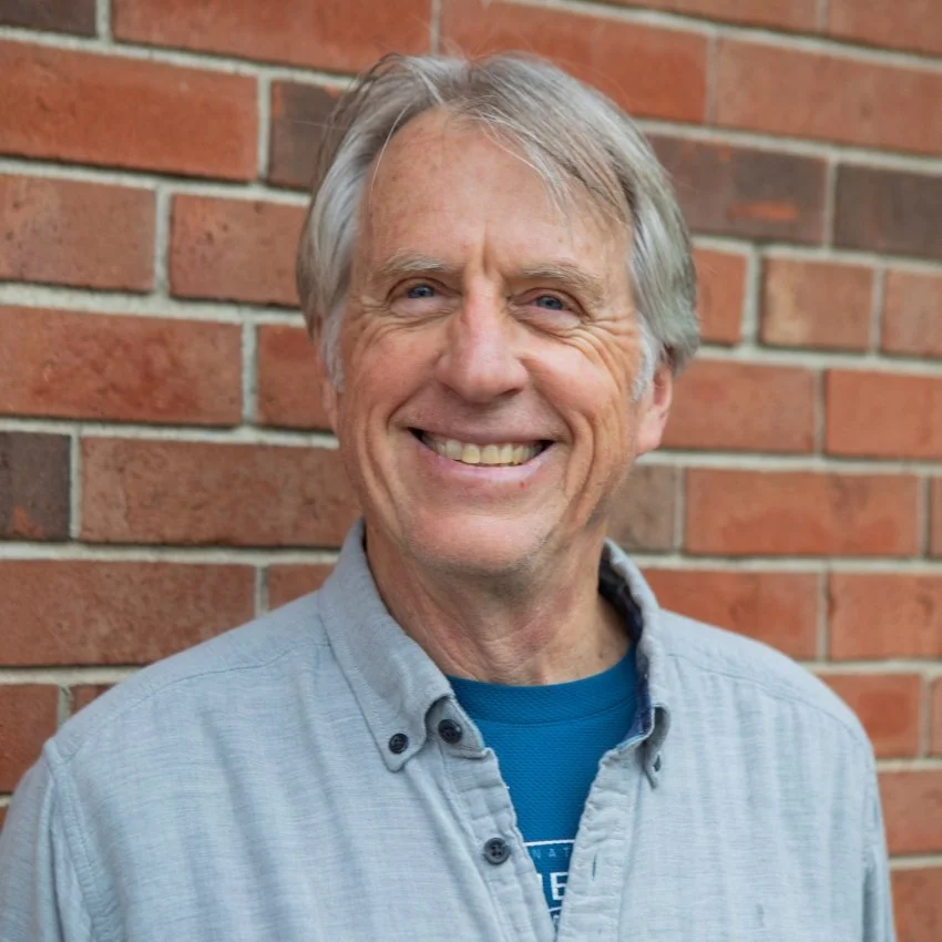 Jericho Road Ministries' Project and Site Manager, Kurt Swanson, smiling at the camera, standing in front of a brick wall.