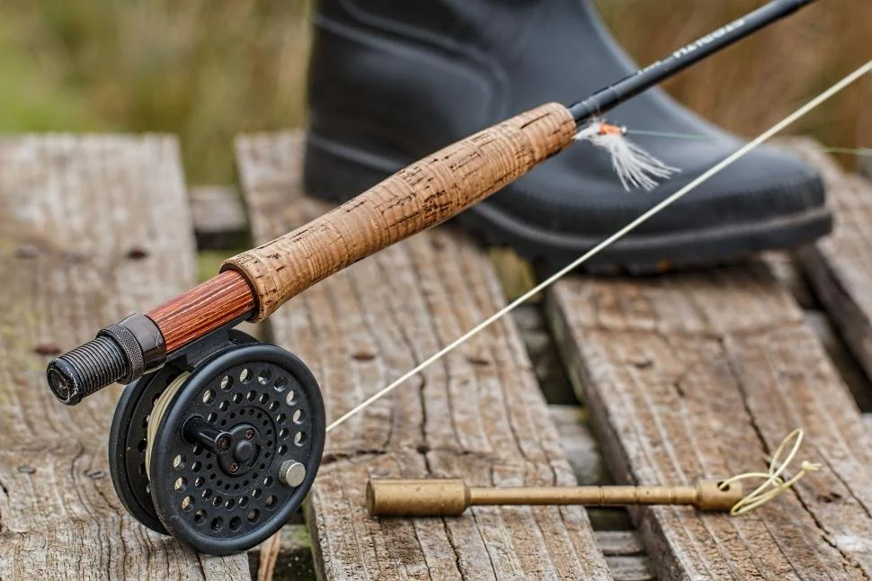 fishing-rod-and-fly-rod-on-wooden-table.jpg