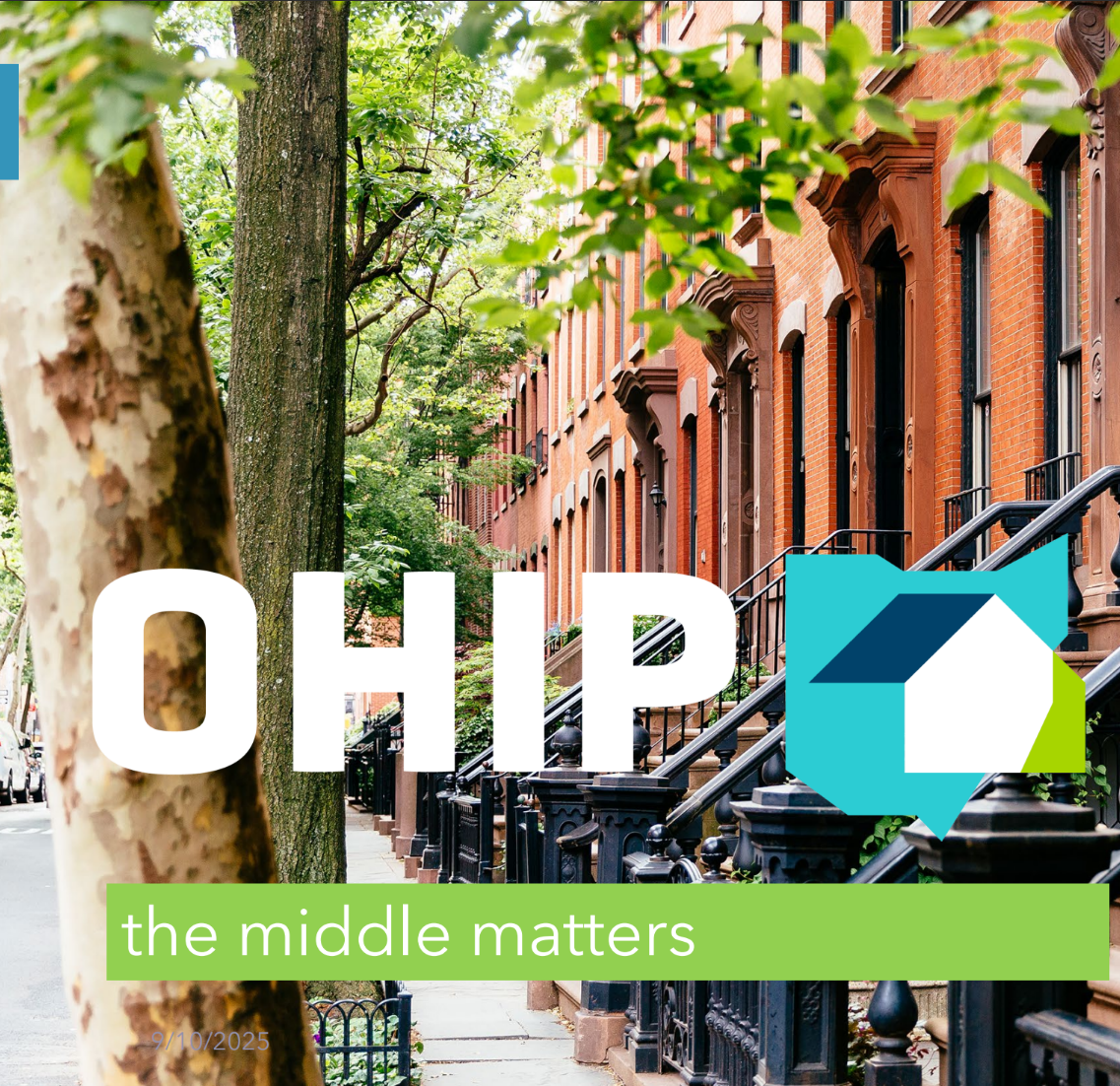 Urban street with brownstone buildings and trees lining the sidewalk