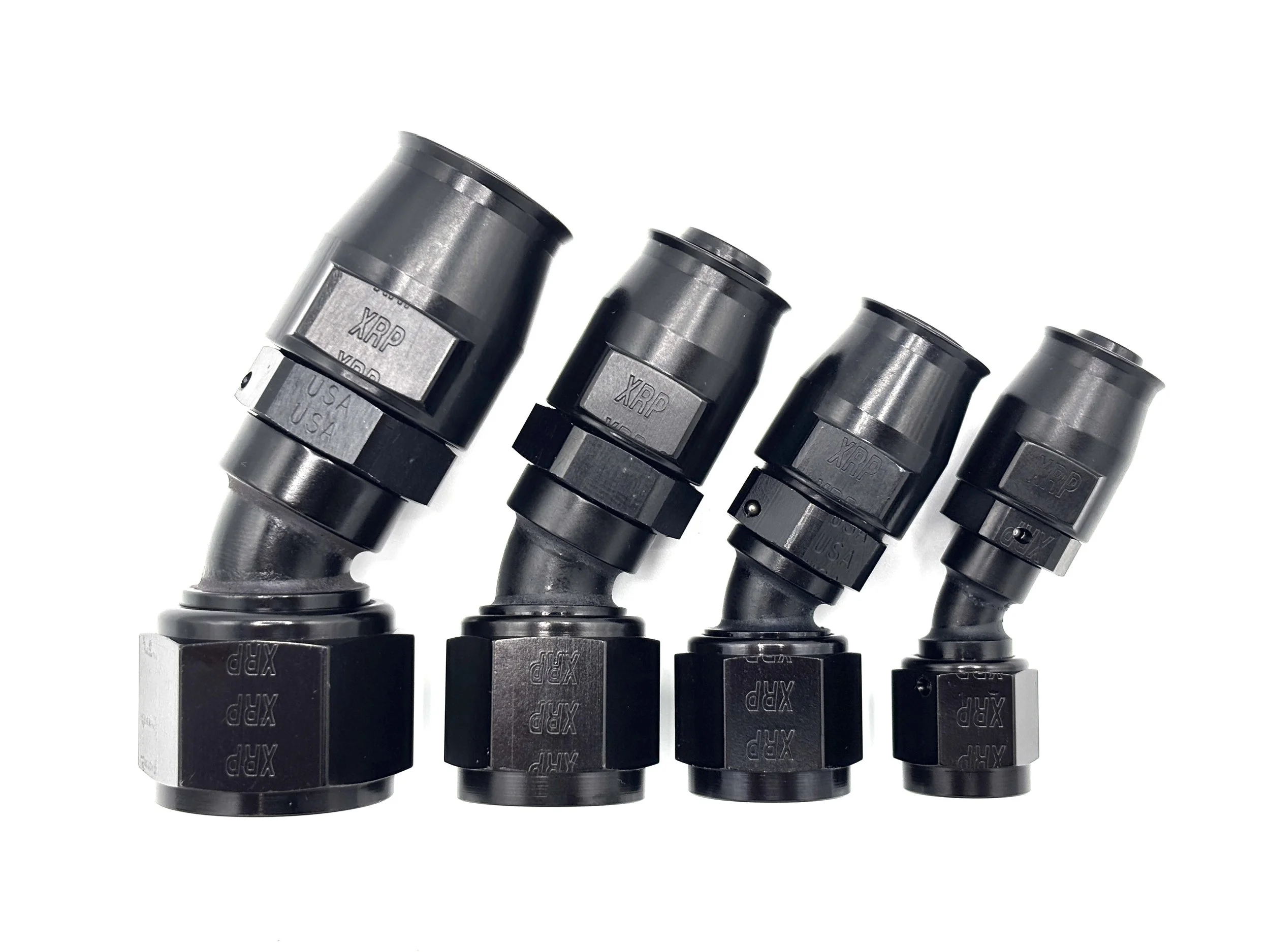 XRP straight swivel Race Reusable hose end to AN female. Black in color. Various sizes from largest to smallest, left to right.
