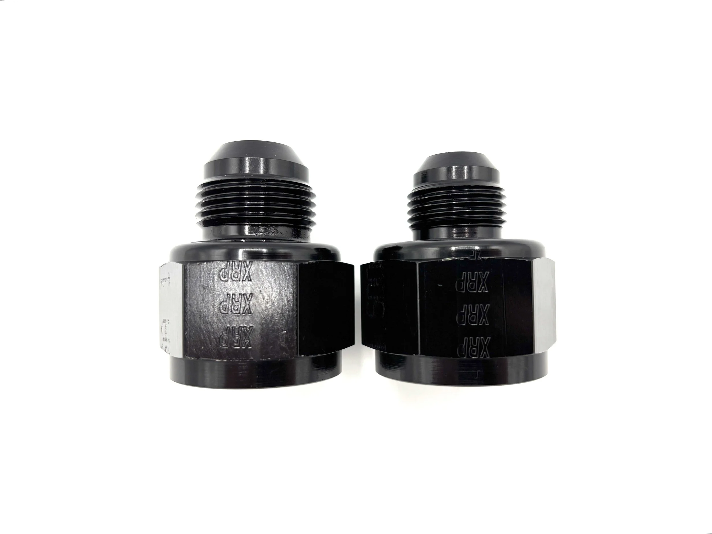 XRP straight -16AN female to AN male reducer fitting. Black in color. Various sizes from largest to smallest, left to right.