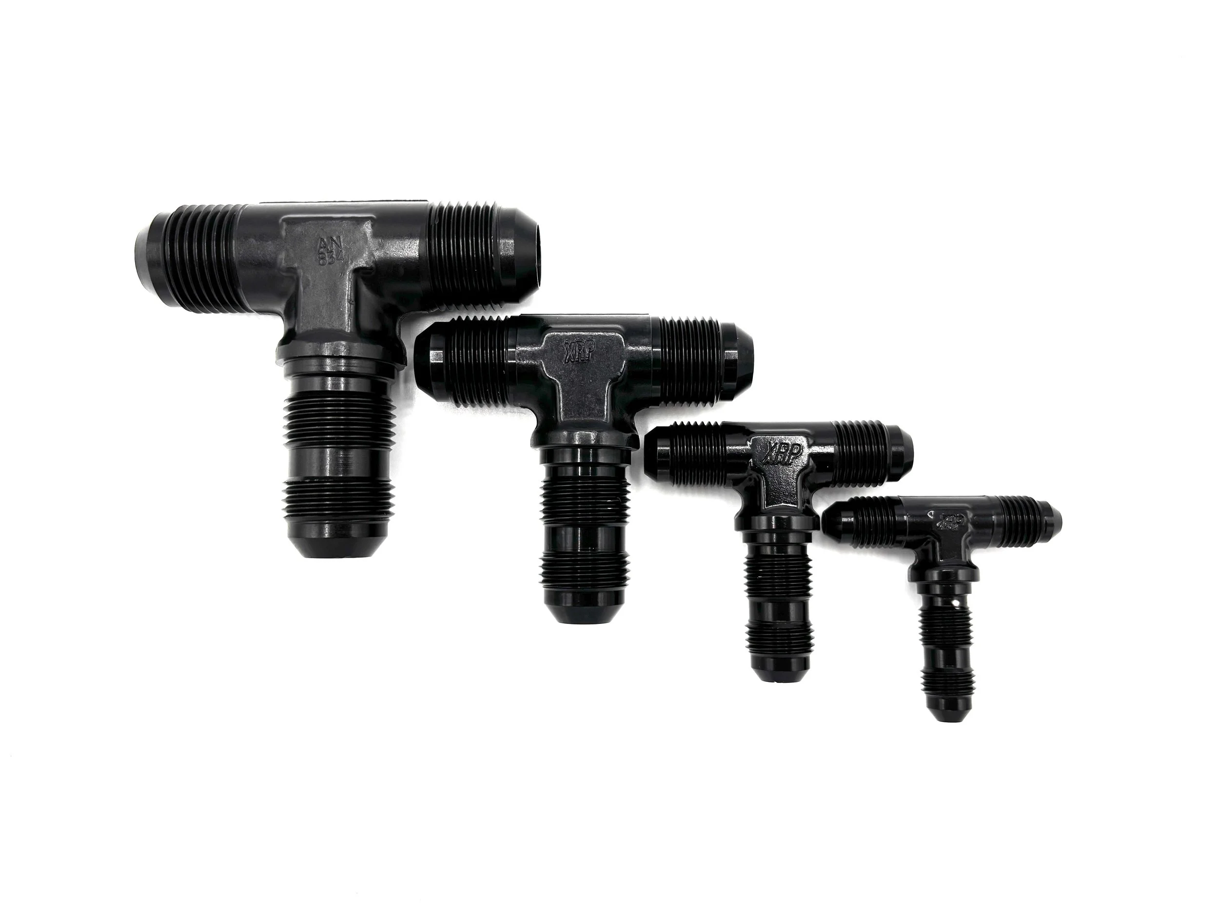 XRP bulkhead tee adapter fitting. Black in color. Various sizes from largest to smallest, left to right.