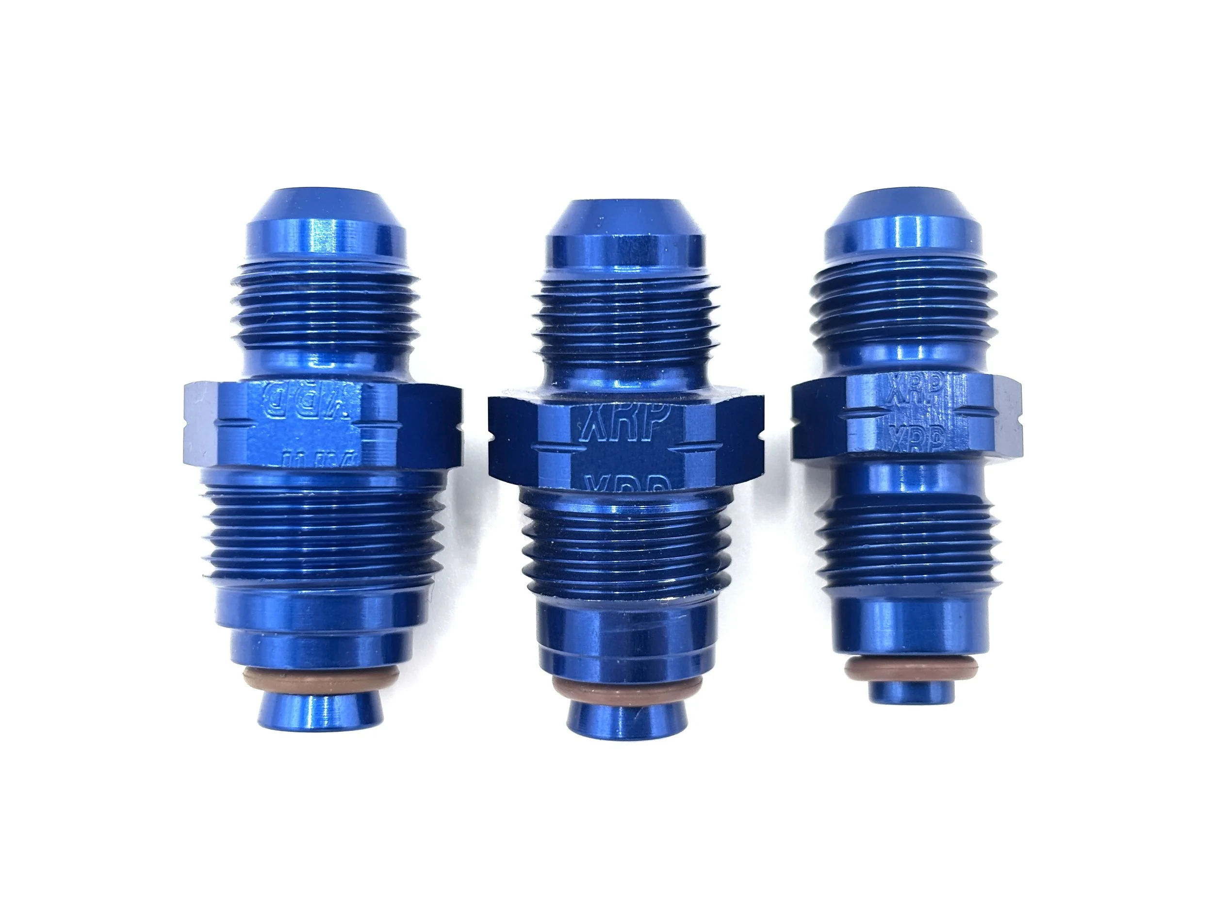 XRP straight -6AN bump tube adapter. Blue in color. Various sizes from largest to smallest, left to right.