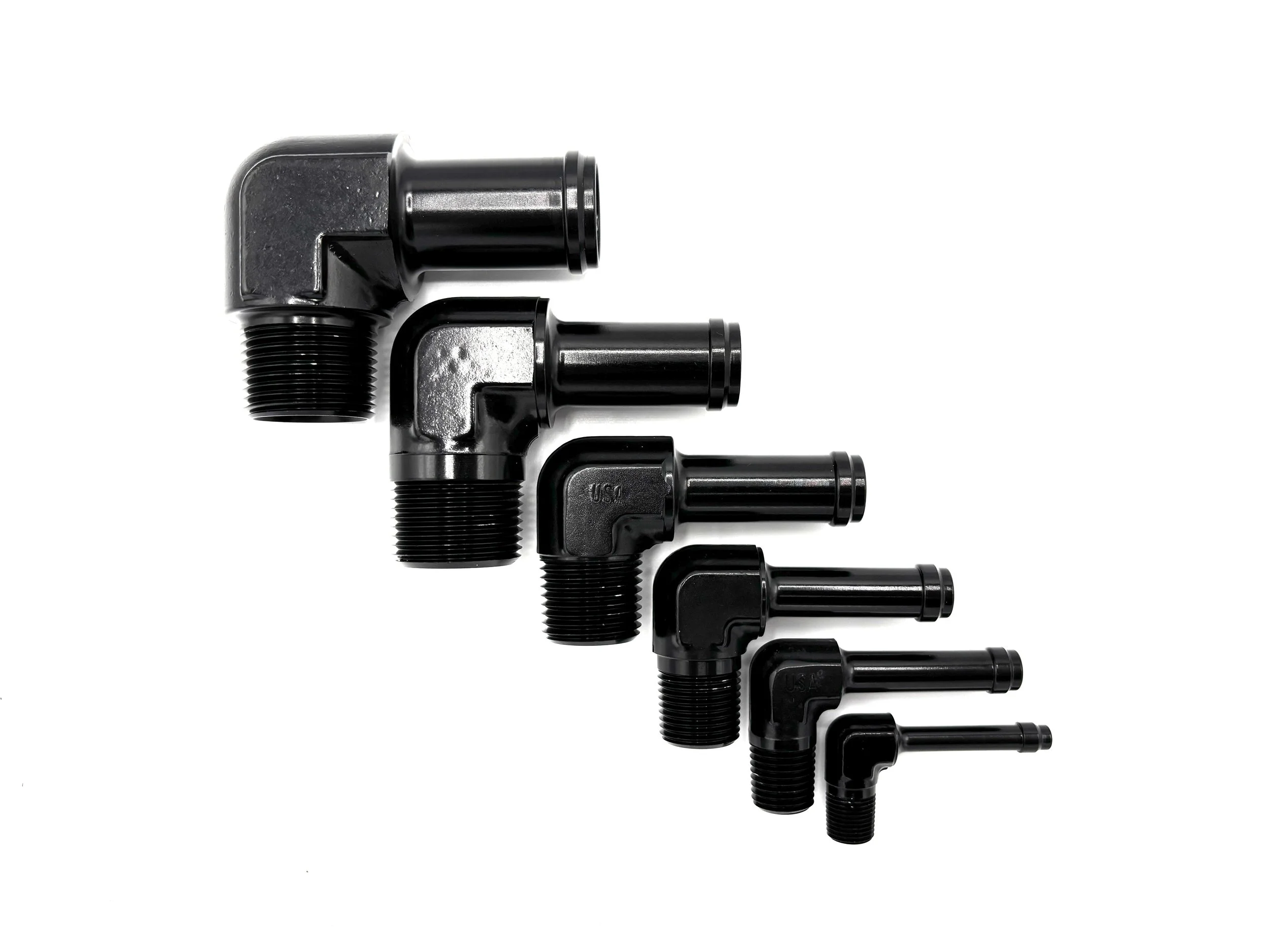 XRP 90 deg. hose barb to NPT adapter fitting. Black in color. Various sizes from largest to smallest, left to right.
