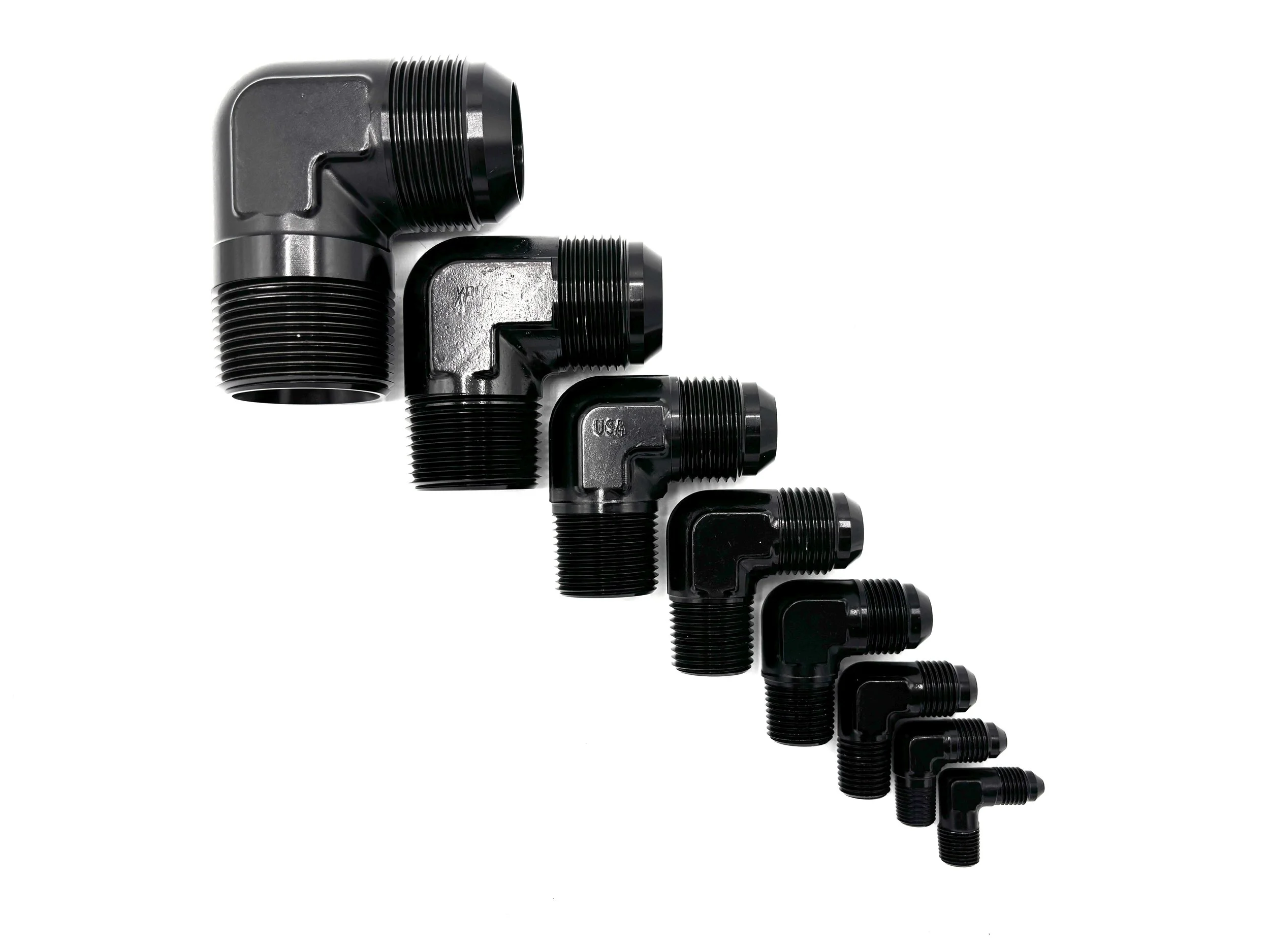 XRP 90 deg. AN male to NPT male adapter fitting. Black in color. Various sizes in a line from largest to smallest, left to right.