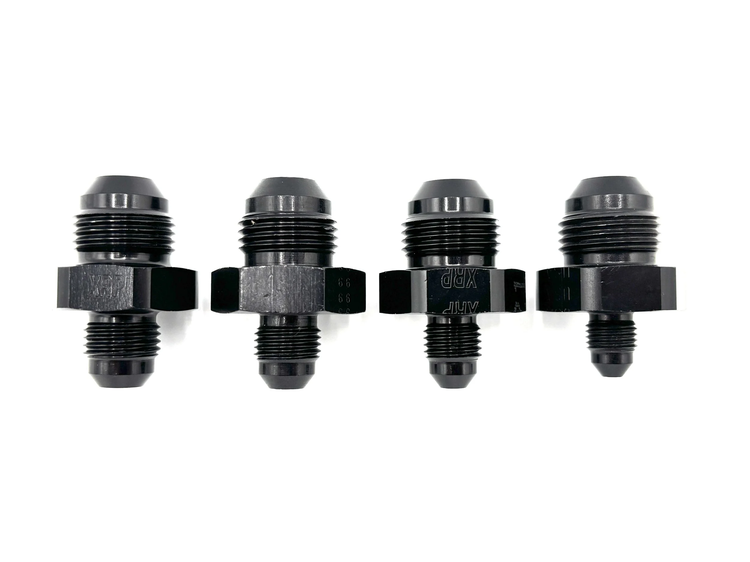 XRP straight -8AN male reducer fitting. Black in color. Various sizes from largest to smallest, left to right.